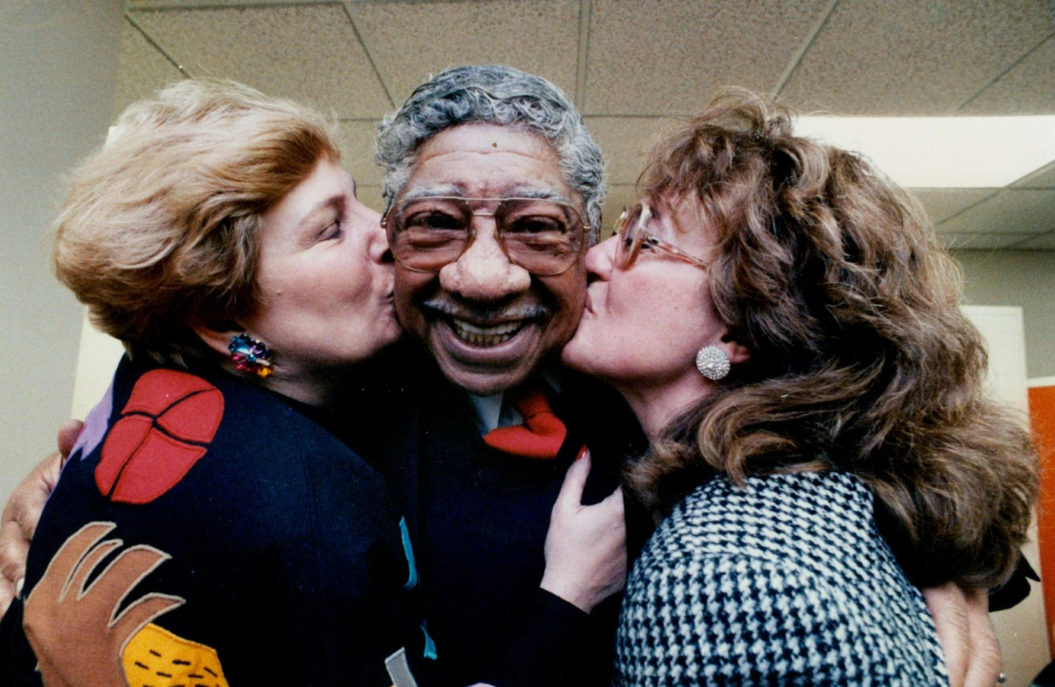 December 30, 1989 Friday Marked the last day of work for three outgoing Minneapolis City Council members (left to right), Barbara Carlson, Van White and Patrica Maas. Carlson and Maas each planted a big smack on White following adjornment of their final meeting. Mike Zerby, Minneapolis Star Tribune