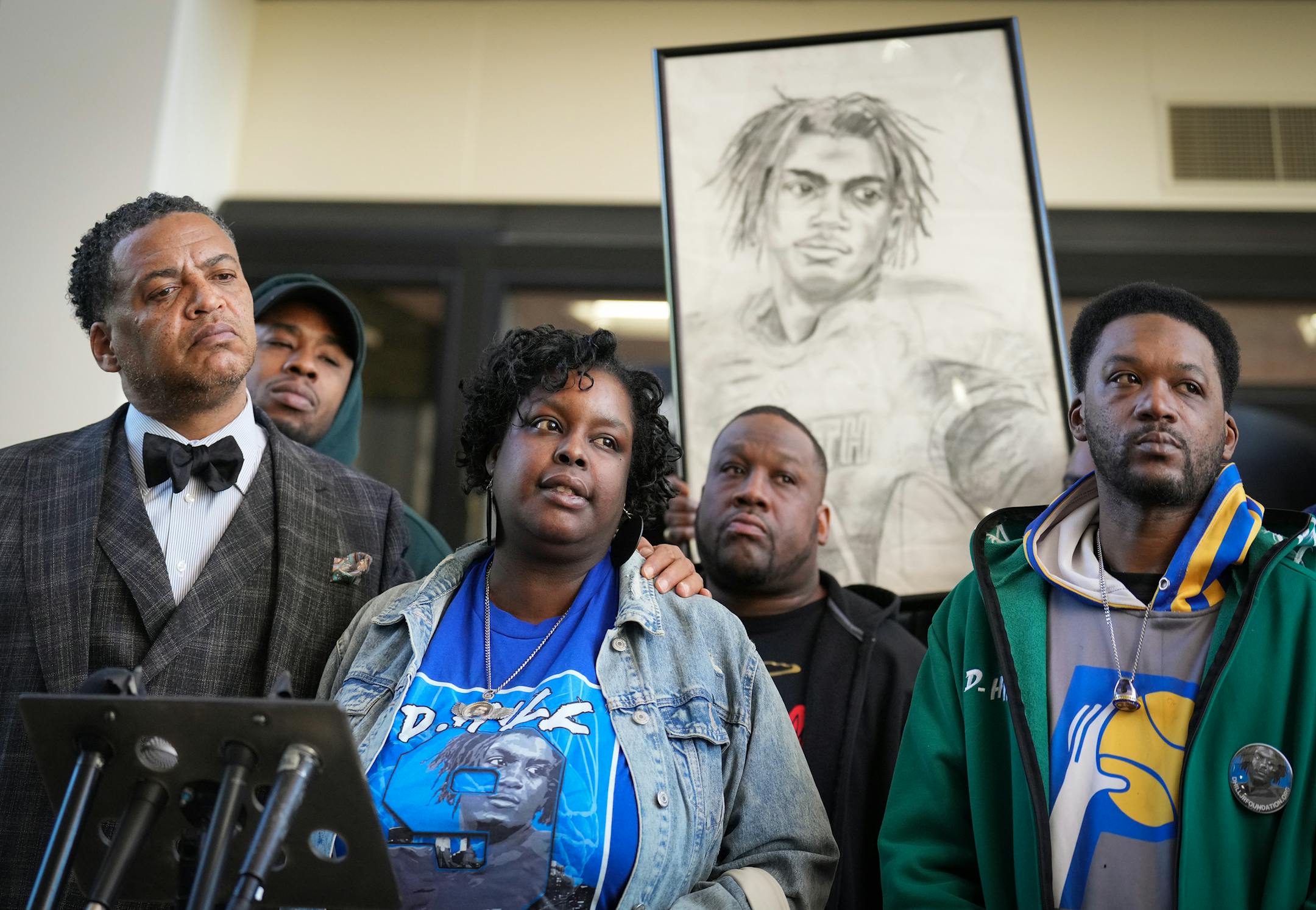 Family attorney William Walker, left, stands alongside Deshaun Hill, Jr.'s parents, Tuesday Sheppard and Deshaun Hill, Sr. as they address the media following at the sentencing of Cody Fohrenkam inside the Hennepin County Government Center.