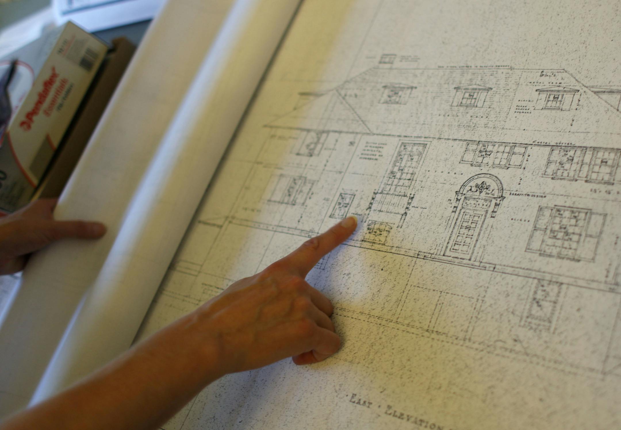 Alissa Pier browses through copies of the 1920s blueprints of the home on Thursday afternoon. ] Architect/homeowner Alissa Pier used original 1920s blueprints to restore this home in north Minneapolis, after a tornado tore off its roof. MONICA HERNDON monica.herndon@startribune.com Minneapolis, MN 07/24/14