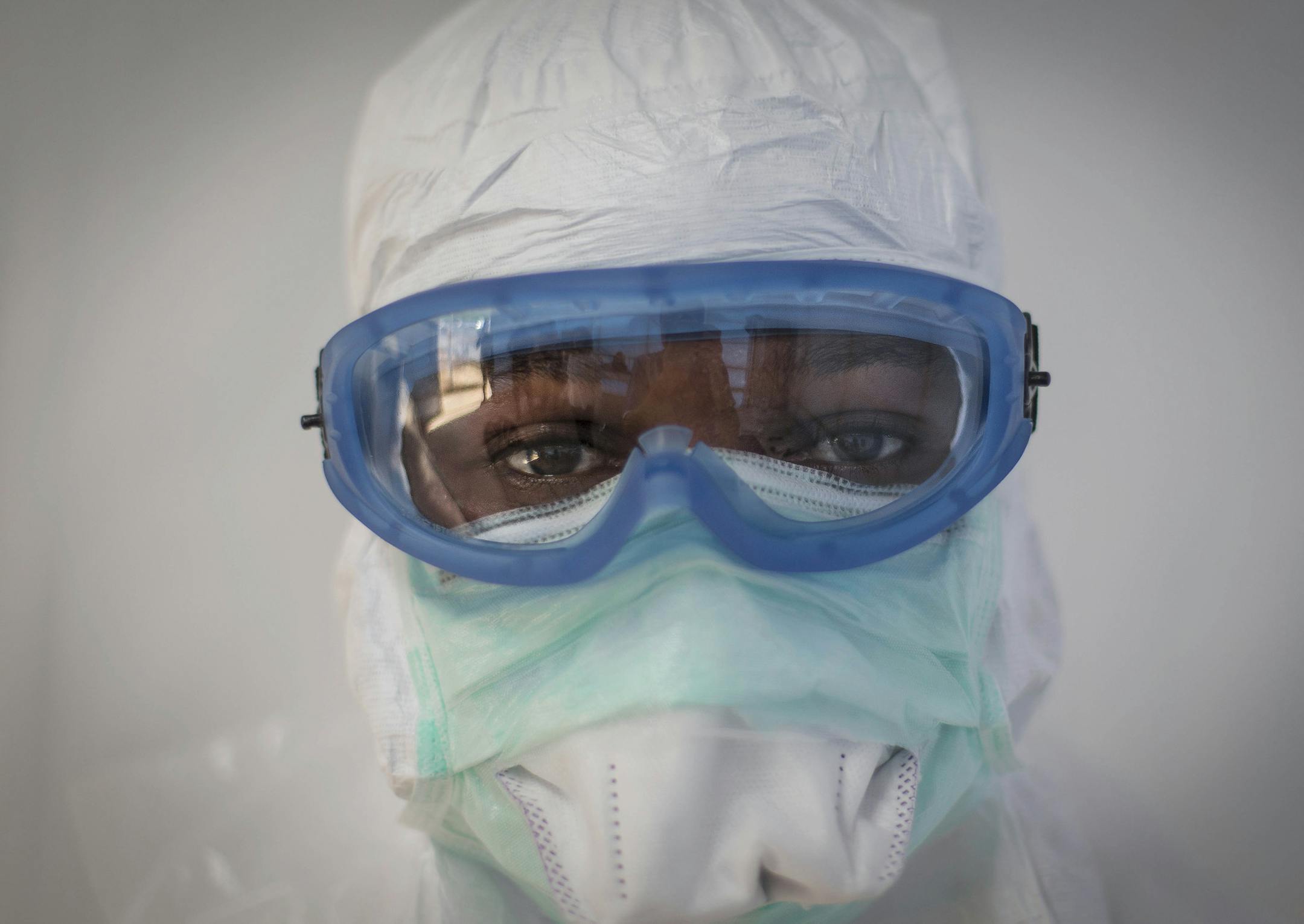 FILE - This undated handout file photo issued by Save the Children UK on Wednesday, Nov. 5, 2014, shows prospective health care workers in the Kerry Town Ebola Treatment Centre being tested on their personal protection equipment procedure in Sierra Leone. Ebola placed third on Google's list of 2014's fastest-rising global search requests, the company said Tuesday, Dec. 16, 2014. (AP Photo/Save the Children UK, Louis Leeson) MANDATORY CREDIT