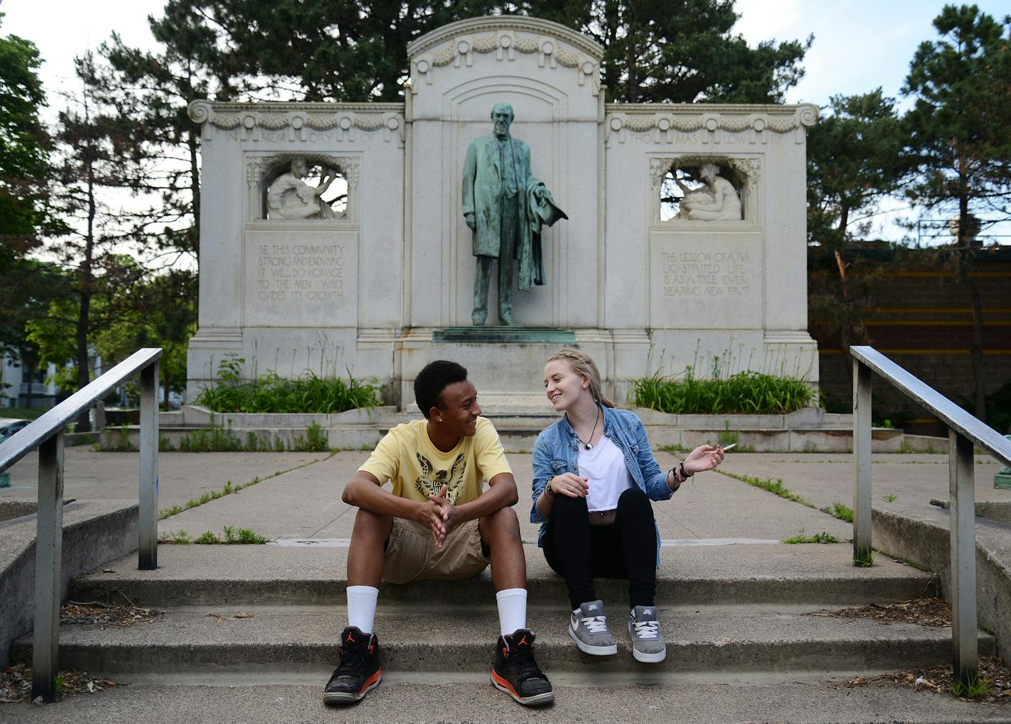 From left, Anthony Stewart, of Bloomington, and Nikki Kettles, of Minneapolis, talked in front of the Thomas Lowry statue on Hennepin Avenue in Minneapolis.