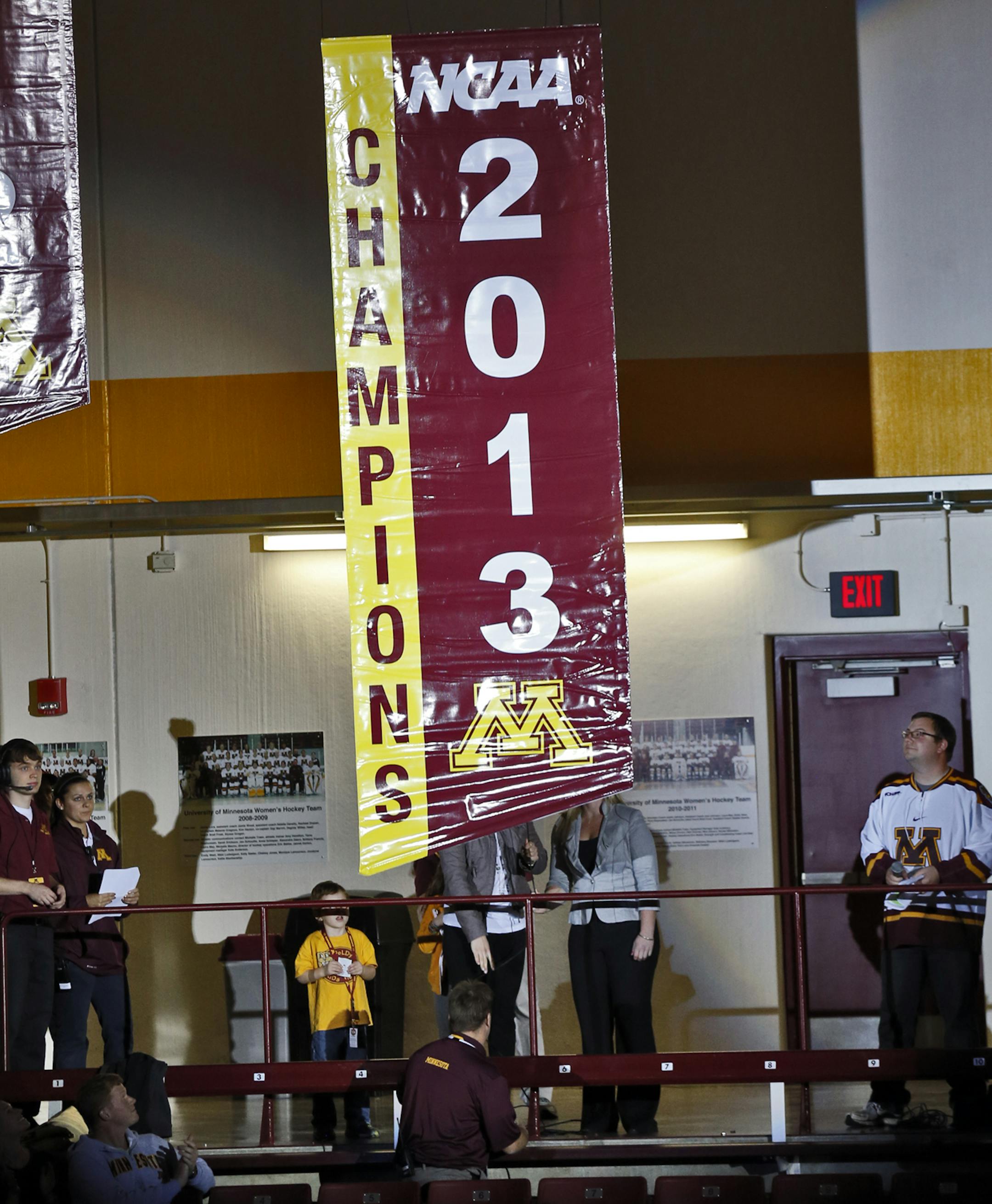 Minnesota Gophers womens hockey game vs. Wisconsin. Minnesota lined up before the start of the game to watch the 2013 National Championship banner be unfurled in the rafters. . (MARLIN LEVISON/STARTRIBUNE(mlevison@startribune.com)