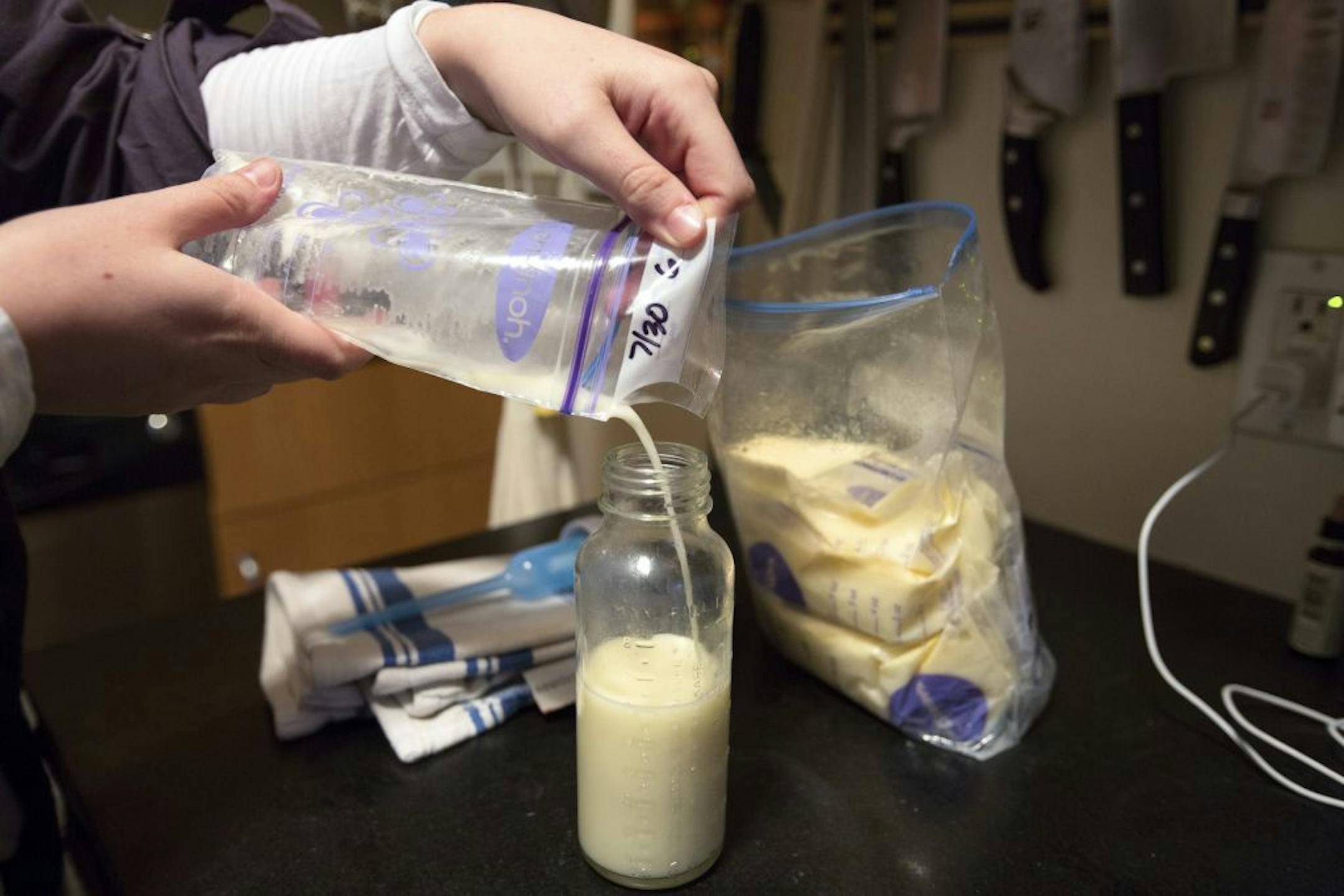 Rachel Holtzman pours donated breast milk from a network of women into a bottle for her son in New York, Oct. 20, 2013. A report found that breast milk bought from two popular websites was often contaminated with high levels of bacteria, including salmonella. �We�ve had the milk of about 30 women and have never had a problem,� she said.