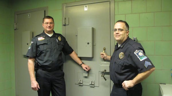 Police Chief Rick Peterson, left, and Capt. Greg Weiss (then a sergeant) were shown at the holding cells of the city's old police department in 2011.