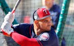 Minnesota Twins catcher Tomas Telis hits in the batting cage, as pitchers and catchers report for their first workout at their spring training basebal