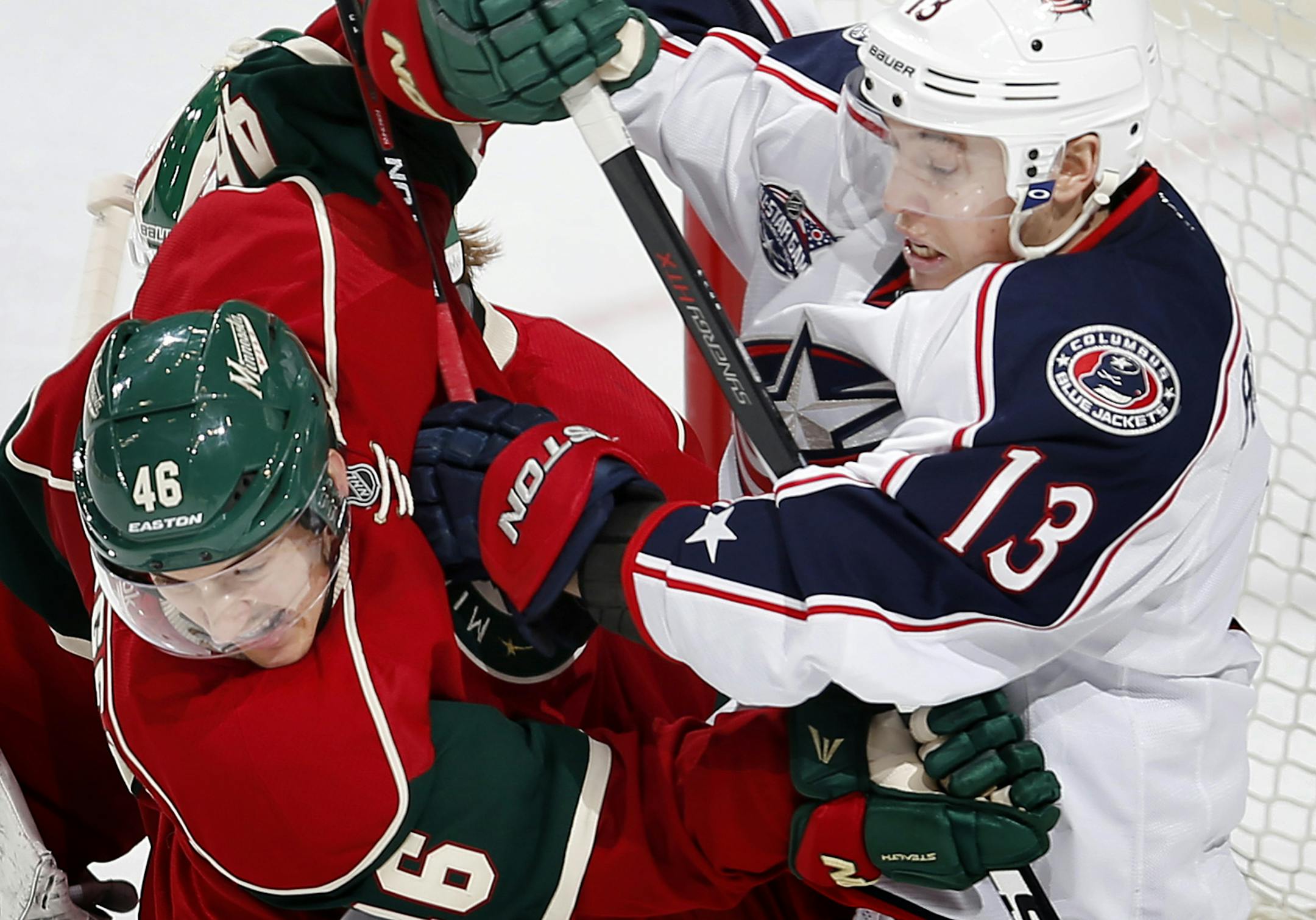Jared Spurgeon (46) and Cam Atkinson (13) fought for position in front of the Wild goal in the third period. ] CARLOS GONZALEZ cgonzalez@startribune.com, January 19, 2015, St. Paul, Minn., Xcel Energy Center, NHL, Minnesota Wild vs. Columbus Blue Jackets