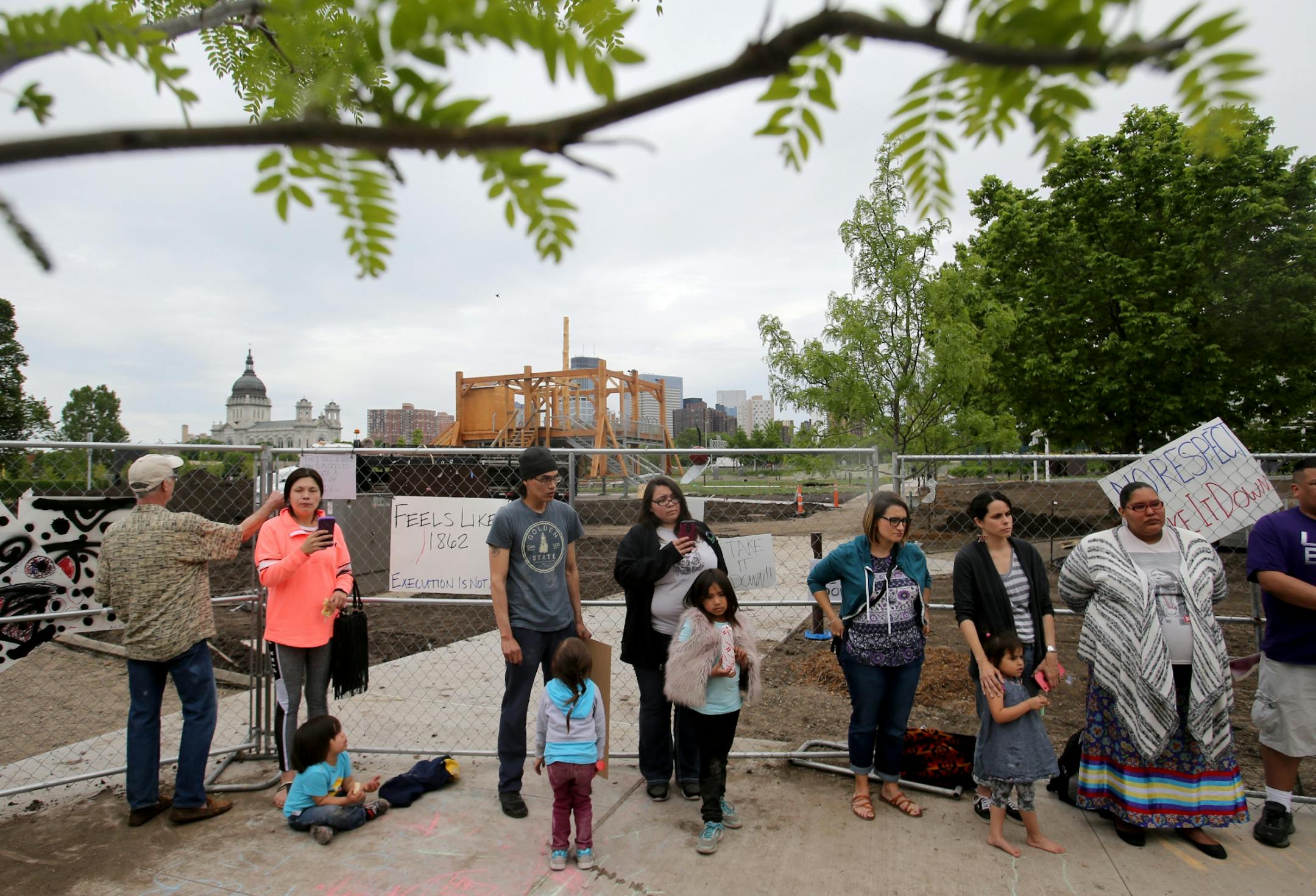 A controversial new sculpture at the Walker Art Center that prompted an outcry among Minnesota's American Indian communities will be dismantled, the director said Saturday. Here, protestors outside a construction fence where inside is a controversial new sculpture at the Walker Sculpture Garden Saturday, May 27, 2017, in Minneapolis, MN.