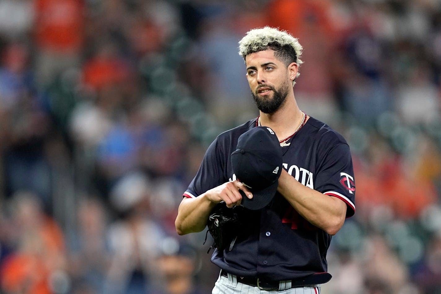 Minnesota Twins relief pitcher Jorge Lopez adjusts his cap after giving up back-to-back home runs during the eighth inning of a baseball game against the Houston Astros Wednesday, May 31, 2023, in Houston. (AP Photo/David J. Phillip)