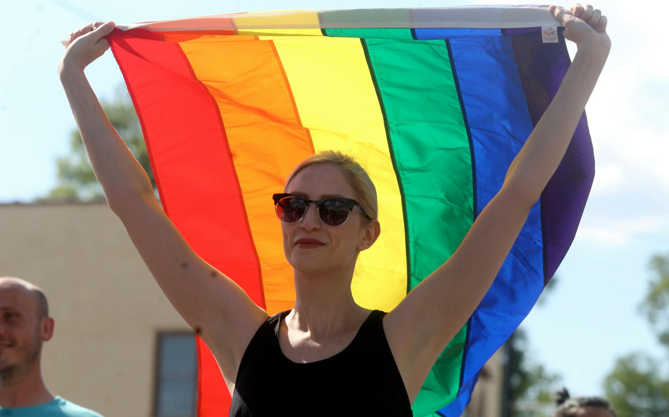 Jessie Childers holds the Pride flag in the air in Florence, Ala., as she marches in the Equality March for Unity and Pride on Sunday, June 11, 2017. Supporters of LGBT rights marched and rallied in the nation's capital and dozens of other U.S. cities on Sunday, celebrating gains but angry over threats posed by the administration of President Donald Trump. (Allison Carter/The TimesDaily via AP)