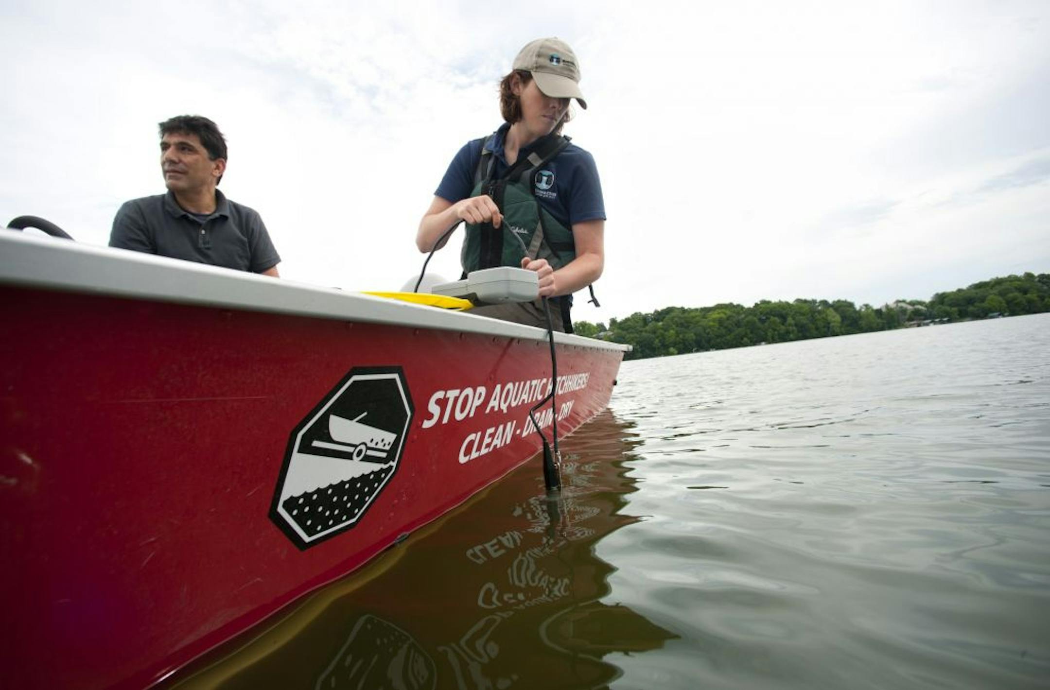 Kelly Dooley of the Minnehaha Creek Watershed District lowered a measuring device into Halsted Bay.