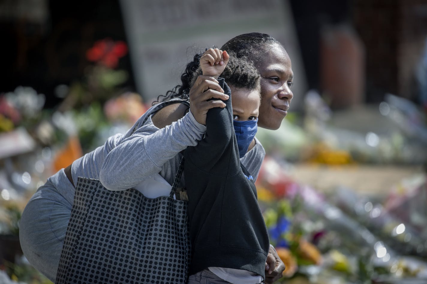 Karnisha Johnson, held her 3-year-old son's Drew Anderson's arm up in support of Terrence Floyd, the brother of George Floyd, as he arrived to the scene where he was killed, Monday, June 1, 2020 in Minneapolis, MN.