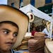 Daniel Fernandez,6, got himself a cowboy hat thanks to his dad. ] Today is Mexican Independence Day. There will be music, singing and other celebratin