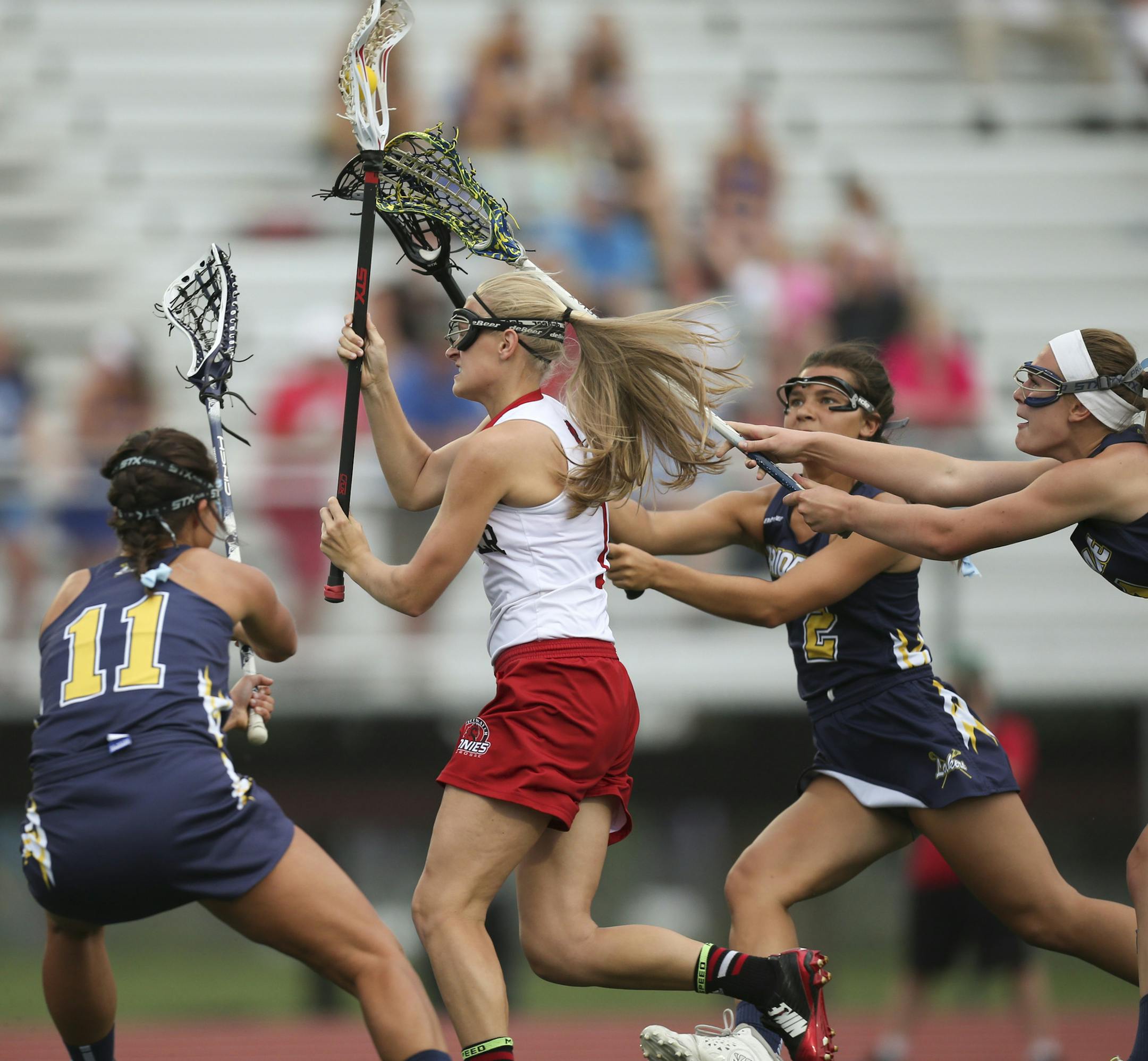 Stillwater's Remi Larson made her way through a trio of Lakers defenders on her way to scoring in the first half Tuesday evening in Minnetonka. They were, from left, Skylar Bantley, Ally Barian, and Sarah Pierson. ] JEFF WHEELER ï jeff.wheeler@startribune.com Stillwater met Prior lake in a girls state lacrosse tournament quarterfinal game at Hopkins High School in Minnetonka Tuesday evening, June 9, 2015.