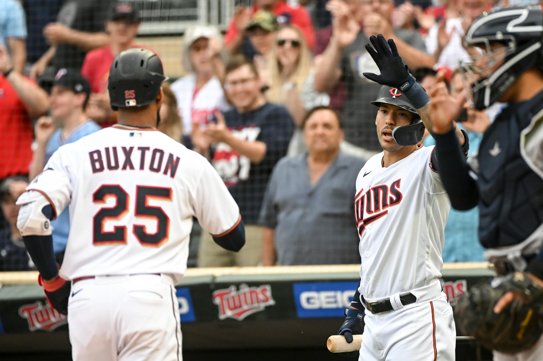 Minnesota Twins center fielder Byron Buxton (25) and shortstop Carlos Correa (4) celebrate a solo home run hit by center fielder Byron Buxton (25) during the bottom of the first inning against the New York Yankees.