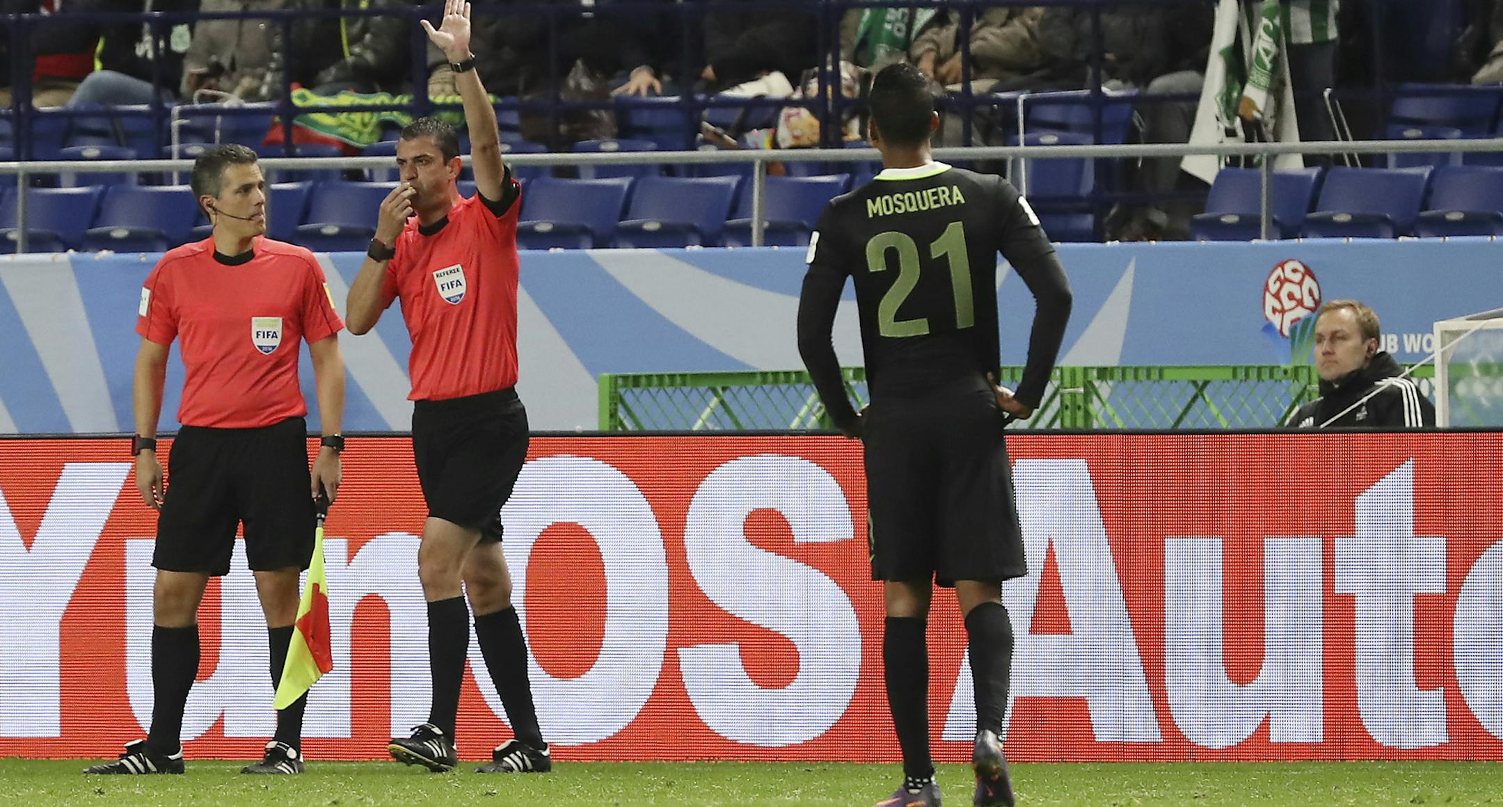 Hungarian referee Viktor Kassai, second left, blows his whistle after checking with the video assistant referee during the match between Kashima Antlers and Atletico Nacional at the FIFA Club World Cup soccer tournament in Suita, west Japan, Wednesday, Dec. 14, 2016. (AP Photo/Eugene Hoshiko)