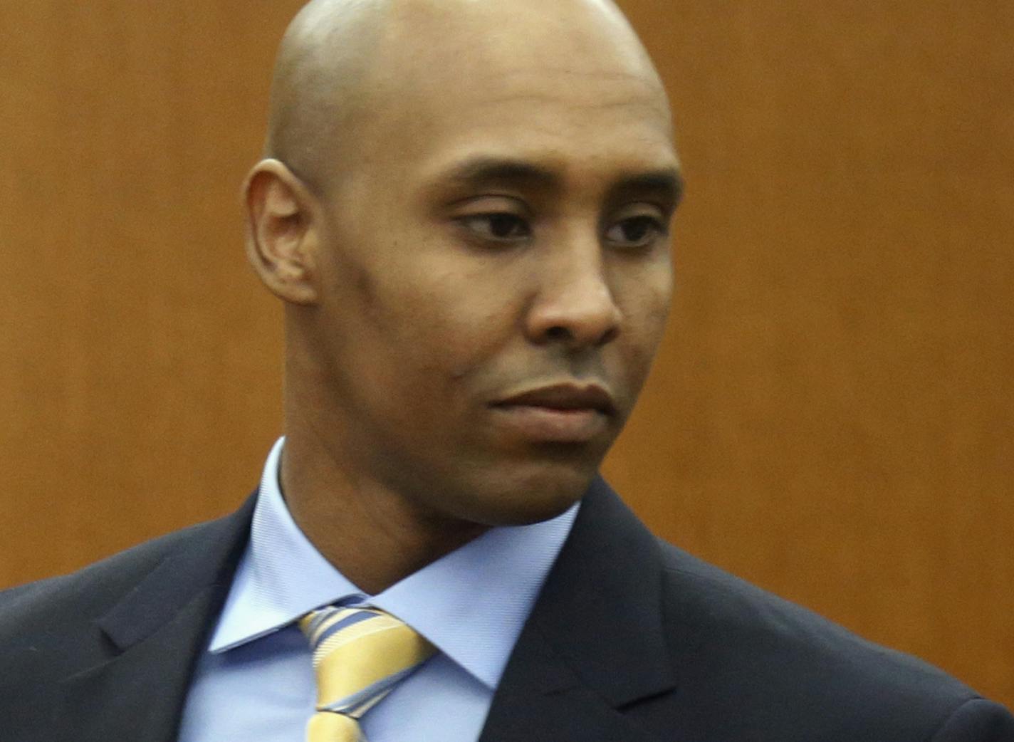 FILE - In this May 8, 2018, file photo, former Minneapolis police officer Mohamed Noor arrives at the Hennepin County Government Center for a hearing in Minneapolis. A lawsuit filed by the family of an Australian woman who was fatally shot by a Minneapolis police officer last year has been put on hold while a criminal case against Noor proceeds. U.S. Magistrate Judge Tony Leung ruled Tuesday, Oct. 2, 2018, that the $50 million civil rights lawsuit filed by the father of Justine Ruszczyk Damond w