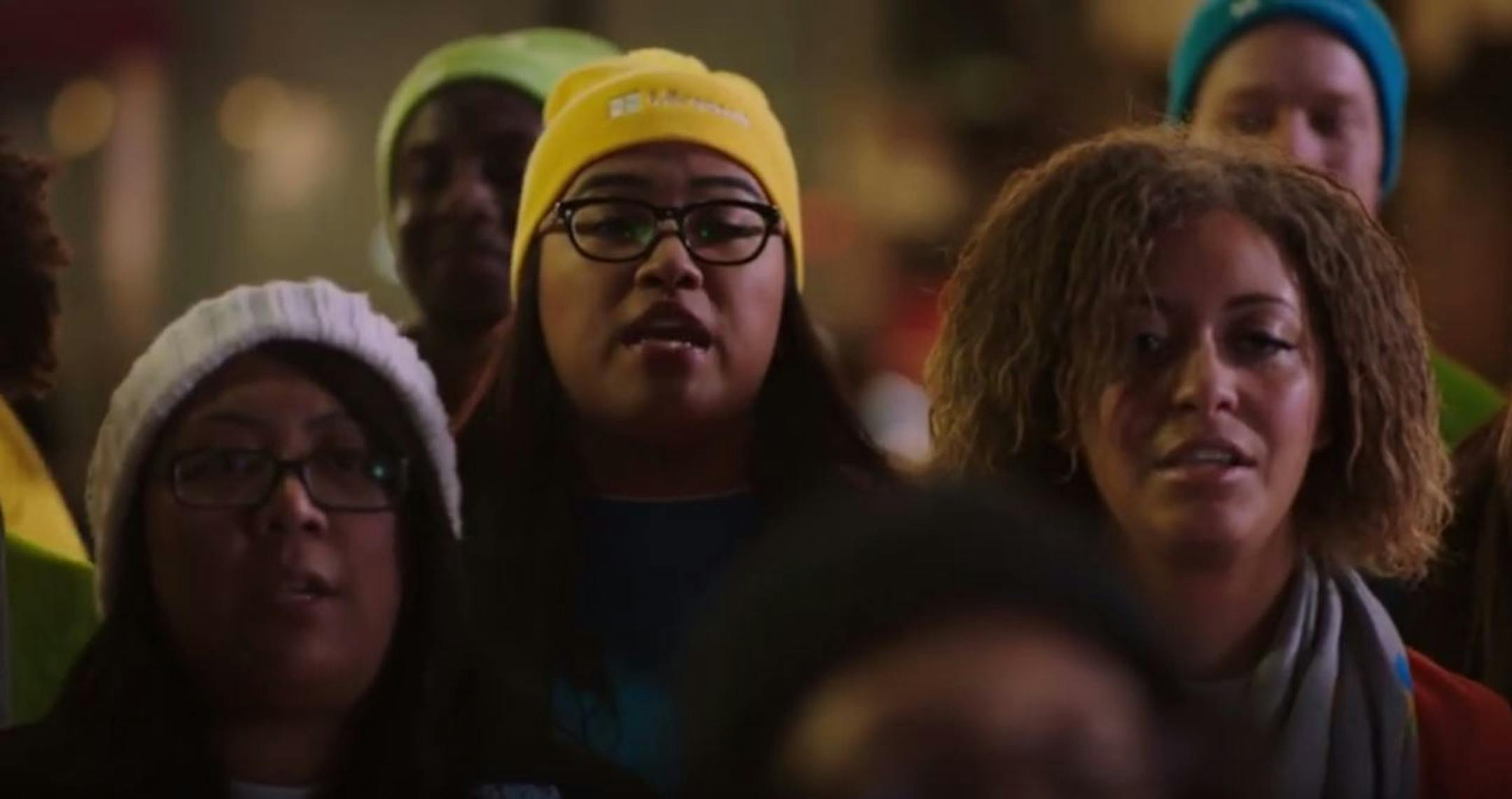 Microsoft employees sing at an Apple Store in a holiday TV commercial posted on YouTube.