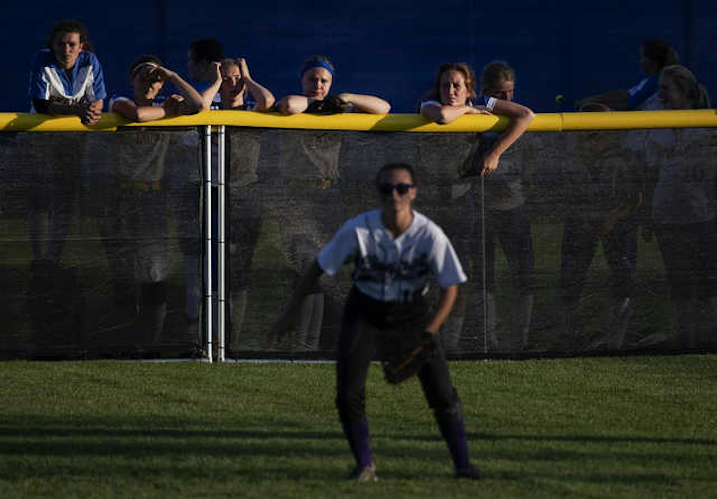 Esko players watched a game from the outfield fence as they waited for their game to start last June 6 at the girls' softball state tournament in North Mankato.