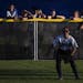 Esko players watched a game from the outfield fence as they waited for their game to start last June 6 at the girls' softball state tournament in Nort
