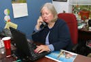 Executive Donna Cook works in her Arlington, Va. office, Friday, Sept. 23, 2005. When menopausal hot flashes caused sweat to run down Cook's face duri
