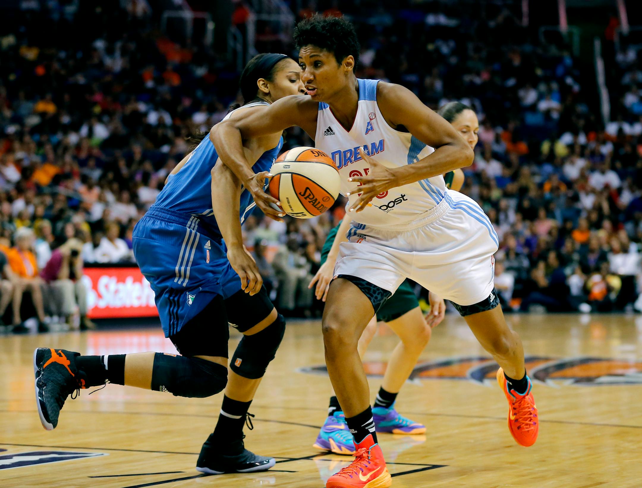 East's Angel McCoughtry, right, of the Atlanta Dream, drives past West's Maya Moore, of the Lynx, during the second half the WNBA All-Star basketball game on Saturday.