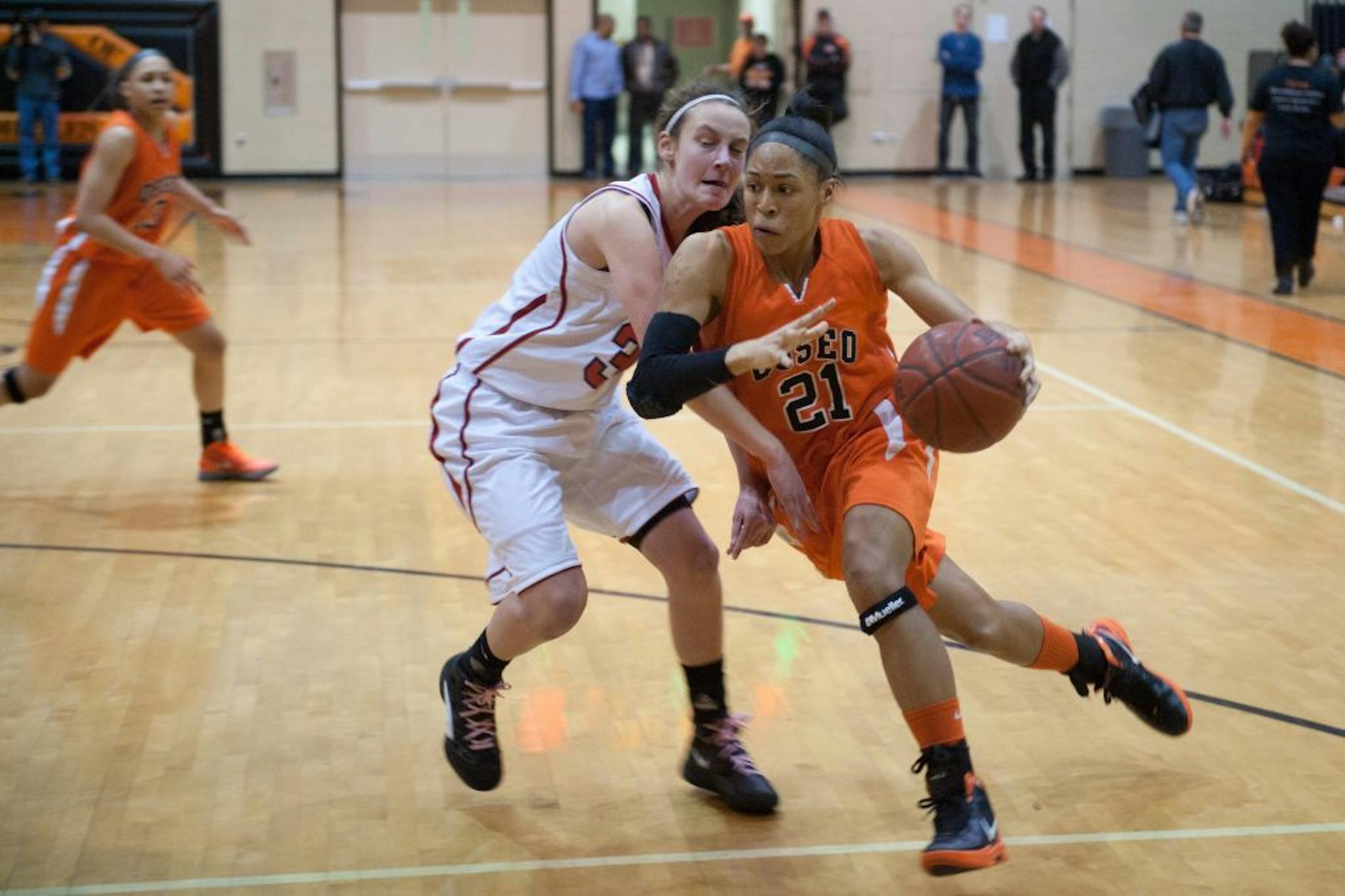 Osseo's Phillis Webb drove past Centennial's Jasmin Bretoi in an Orioles' victory Feb. 24. The 5-10 junior forward says her strong point is her quickness.