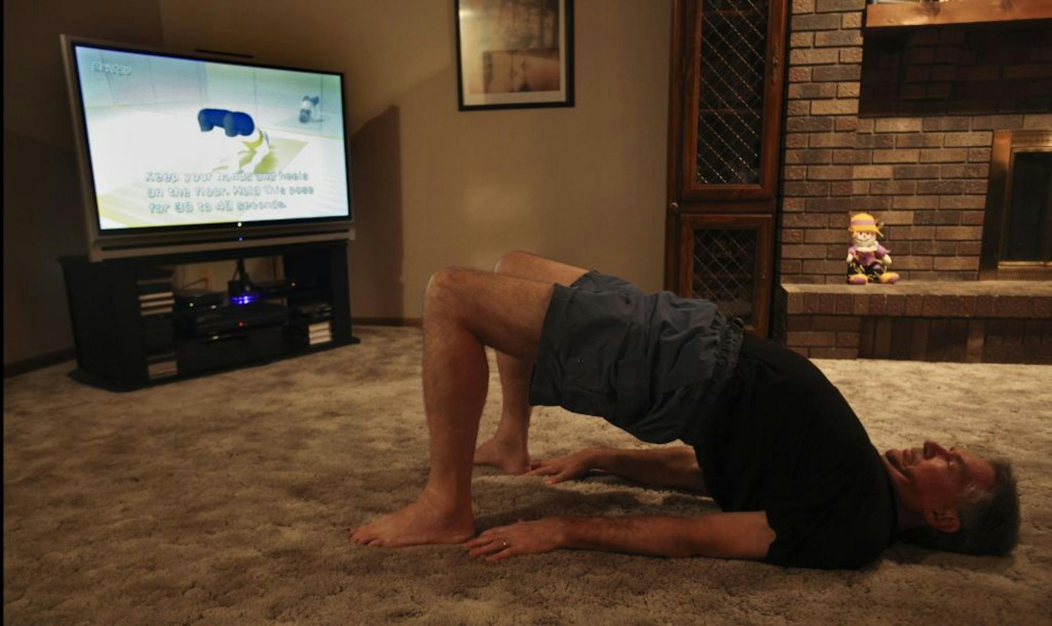 Larry Teckenbrock went through his 19 minute yoga workout he created on Wii Fit Plus in his home in Eagan Thursday, October 27, 2011