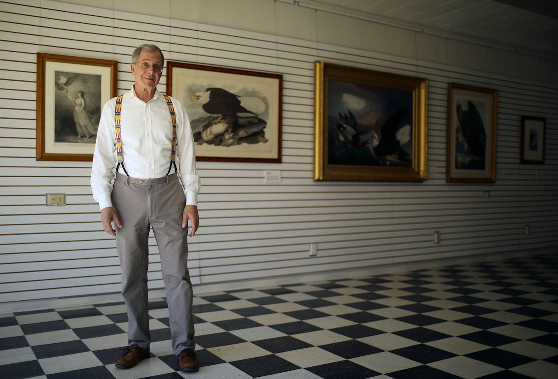 Preston Cook in one of the buildings that the National Eagle Center has plans to renovate, in part to display Cook's collection of eagle-related fine art, examples of which are behind him.