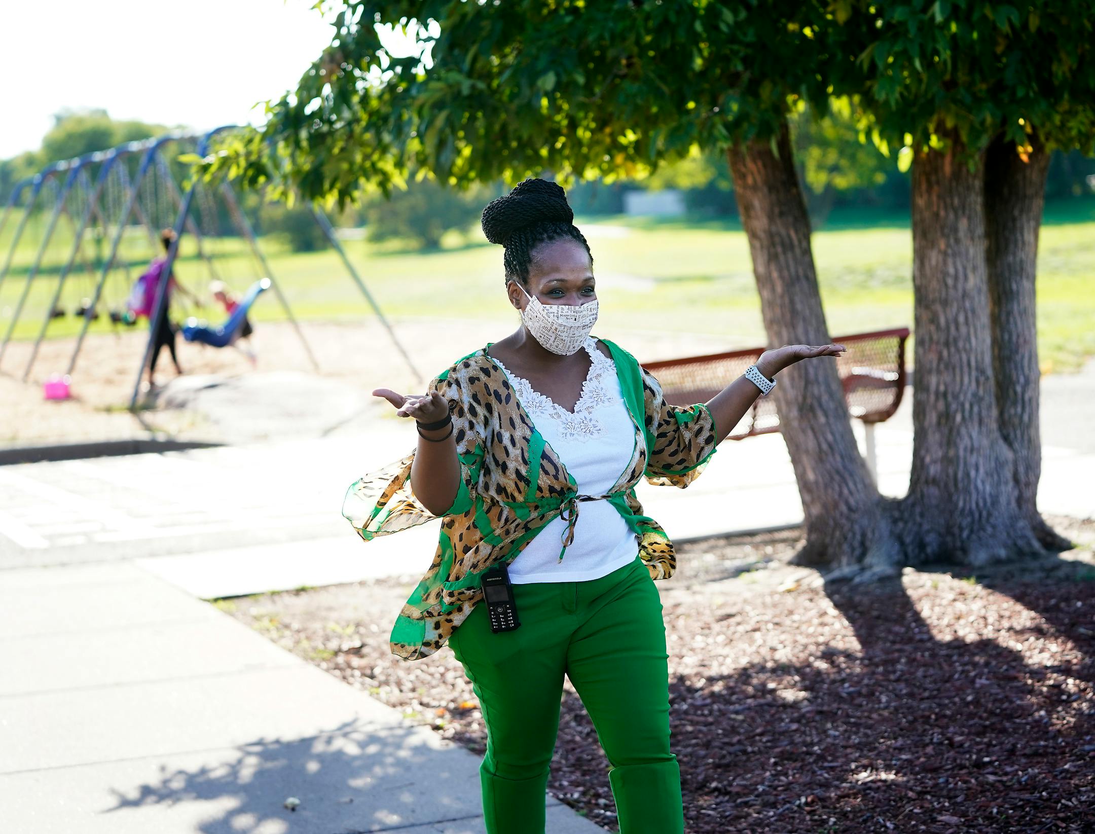 New Hoover Elementary School principal Keisha Davis gestured to an arriving student and parent before the start of the first day of school Tuesday in Coon Rapids.   ]