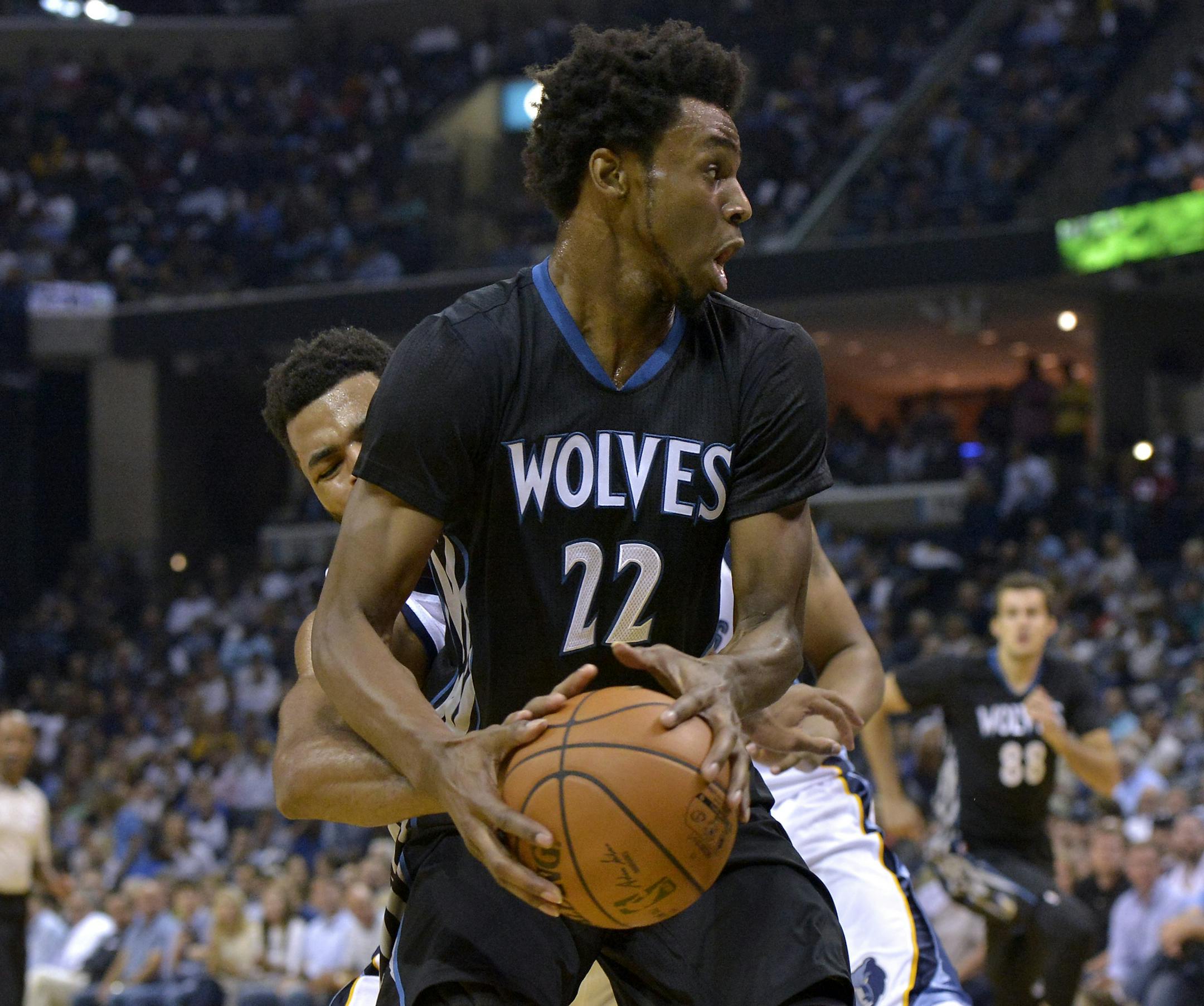 Minnesota Timberwolves forward Andrew Wiggins (22) controls the ball as Memphis Grizzlies guard Andrew Harrison tries to steal in the first half of an NBA basketball game Wednesday, Oct. 26, 2016, in Memphis, Tenn. (AP Photo/Brandon Dill)