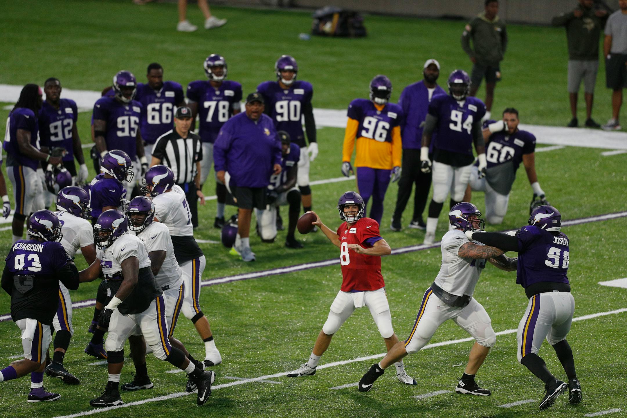 Minnesota Vikings quarterback Kirk Cousins (8) throws a pass during a night practice during training camp at TCO Performance Center in Eagan, Minn., on Saturday, Aug. 4, 2018.