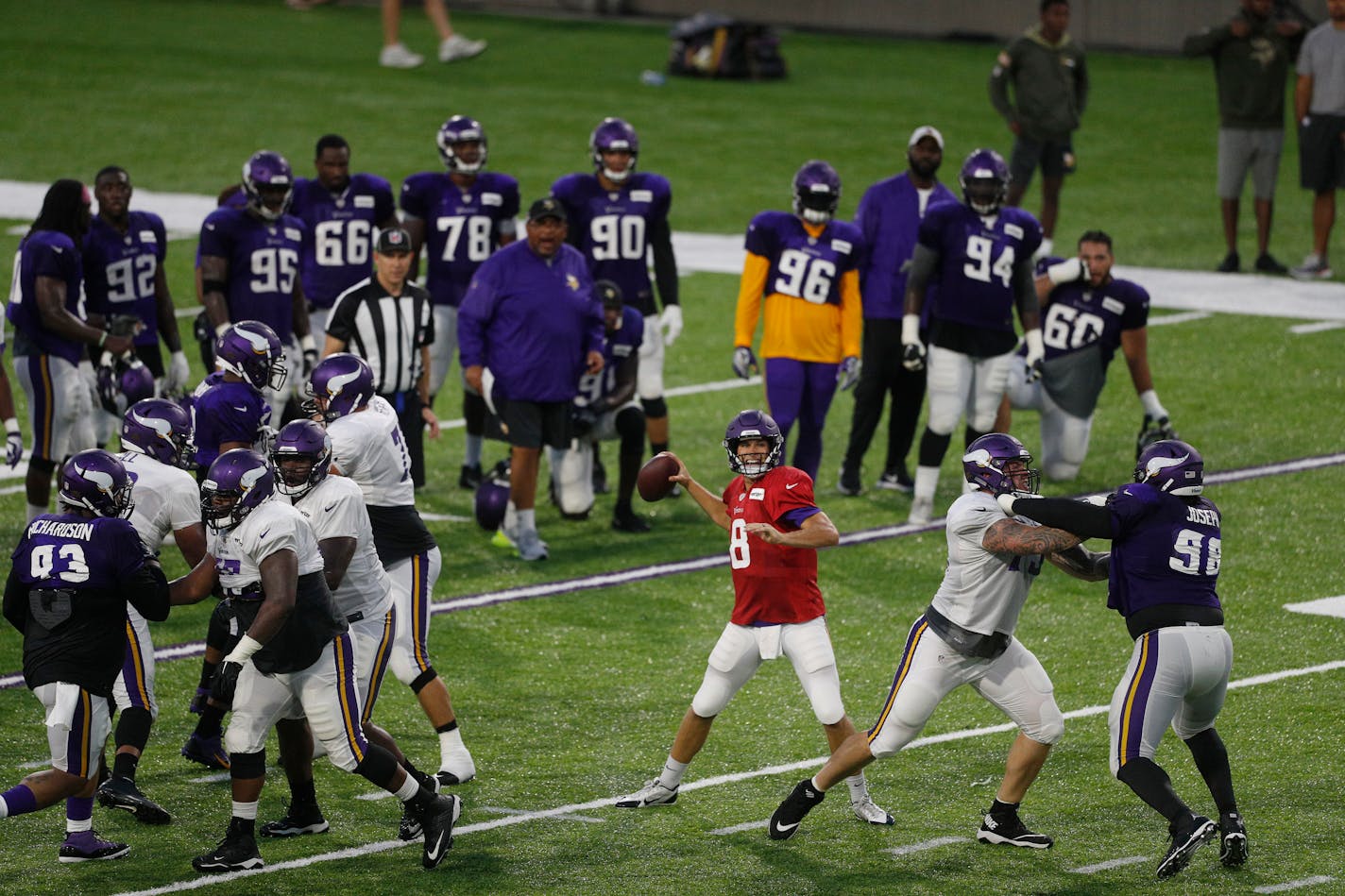 Minnesota Vikings quarterback Kirk Cousins (8) throws a pass during a night practice during training camp at TCO Performance Center in Eagan, Minn., on Saturday, Aug. 4, 2018.