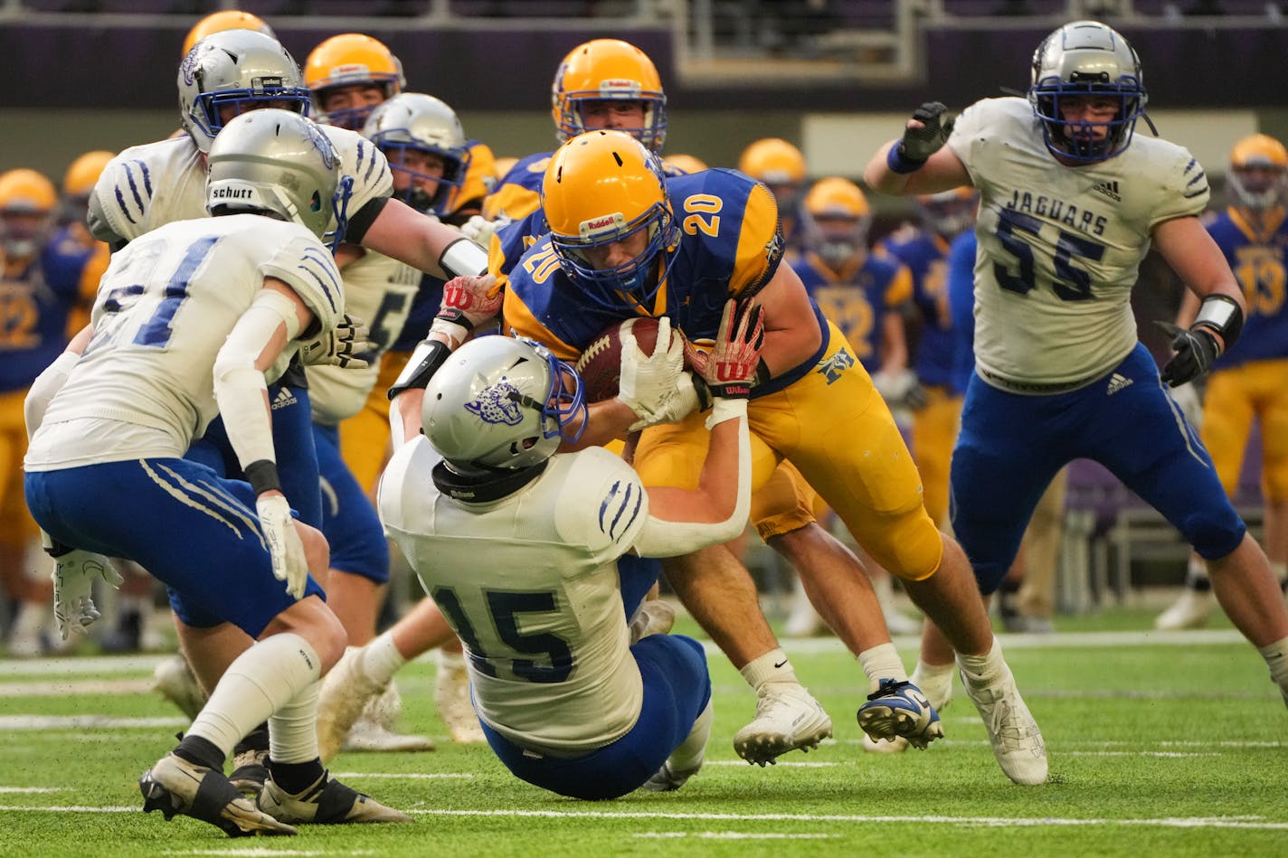 Minneota's Ryan Meagher (20) rumbles over Belgrade-Brooten-Elrosa's Owen Paulson (15) for a first down in the first half of a Class 1A state semifinal game in Minneapolis, Minn., on Saturday, Nov. 18, 2023. ] SHARI L. GROSS • shari.gross@startribune.com