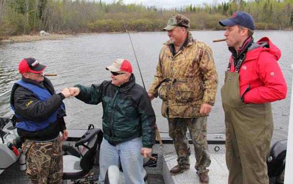 Governor Dayton thanks his fishing guide, Buck Lescarbeau, with a fist bump after a successful fishing expedition. Governor Mark Dayton, Majority Lead