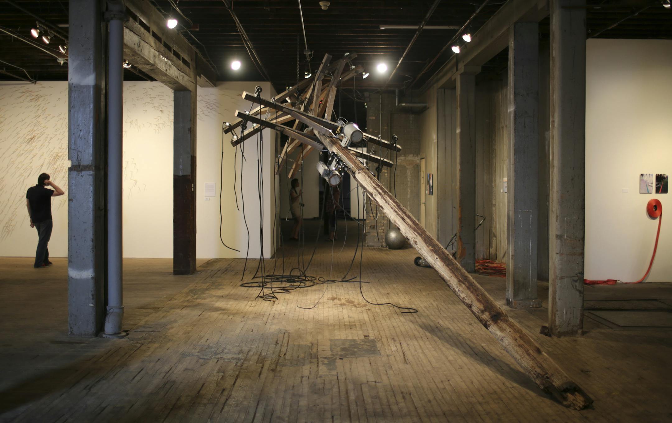 A utility pole that's part of the Americana show currently on view at The Soap Factory . The piece, by artist ] JEFF WHEELER ‚Ä¢ jeff.wheeler@startribune.com The Soap Factory's Executive Director Ben Heywood is donning a curator's hat for "Americana," a look at American politics and culture through 3 videos, 4 installations, and a photo project by nine emerging artists. The show is the British-born curator's effort to assess "the assumptions and stereotypes of this mythic land,