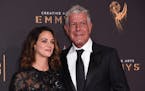 Asia Argento, left, and Anthony Bourdain arrive at night one of the Creative Arts Emmy Awards at the Microsoft Theater on Saturday, Sept. 9, 2017, in 