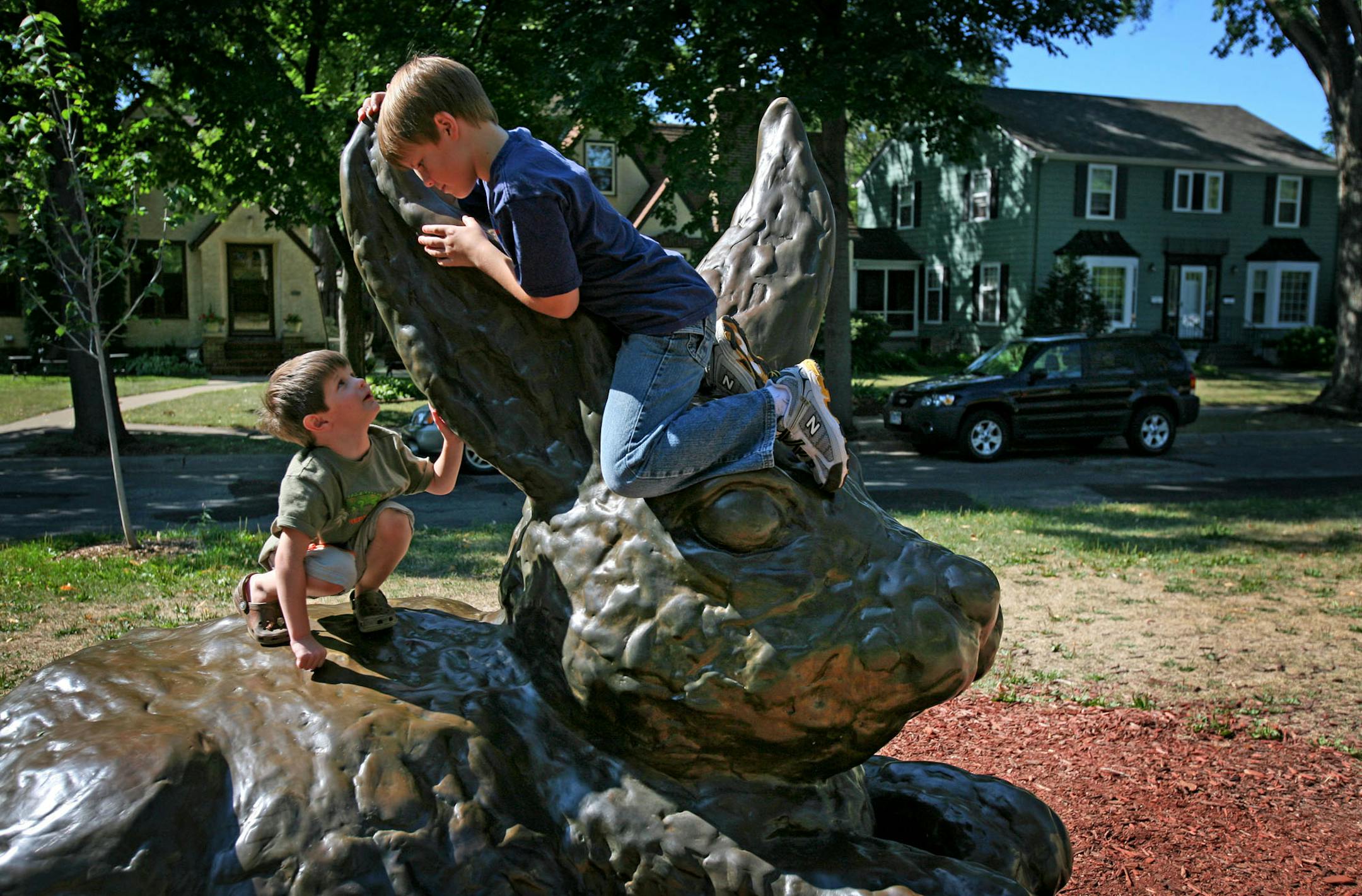 Antonio Rosati, 4, and his neighbor Corey Hagen, 11, played on a bronze rabbit sculpture on Minnehaha Avenue in Minneapolis Monday morning while out on a walk. The boys are two of many children in the neighborhood who love to climb and play on the local sculpture.