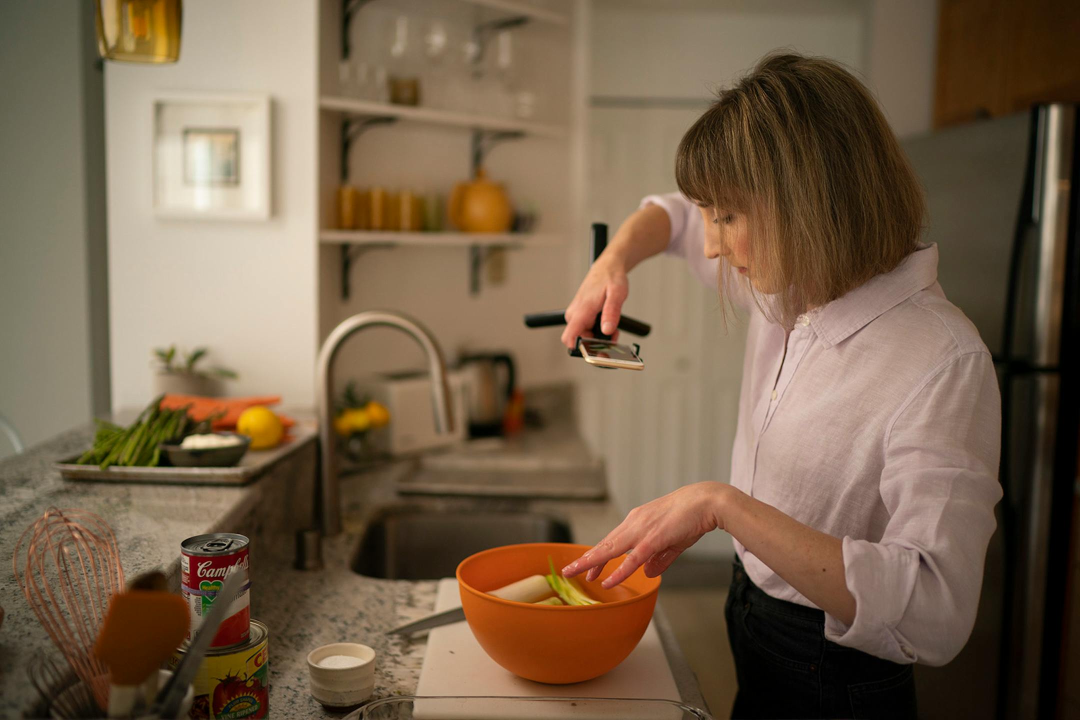 Chef Karyn Tomlinson shot a detail of leeks soaking in water while preparing an asparagus leek soup. Since the pandemic began, former Corner Table chef Karyn Tomlinson has been a prolific poster to Instagram, offering free cooking lessons with her show "Karyn's Quarantine Kitchen." She was photographed producing a segment on preparing pureed soups Thursday afternoon, April 23, 2020 in the kitchen of her condo.