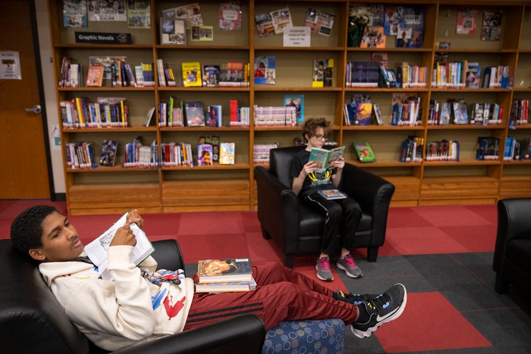 Sixth-graders Isaac Firkus, left, and James Dalbacka-Hoogenboom relaxed and read books in the school library at Franklin STEAM Middle School in Minneapolis on Wednesday.