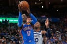 Oklahoma City guard Dennis Schroder shoots in front of Timberwolves guard Josh Okogie