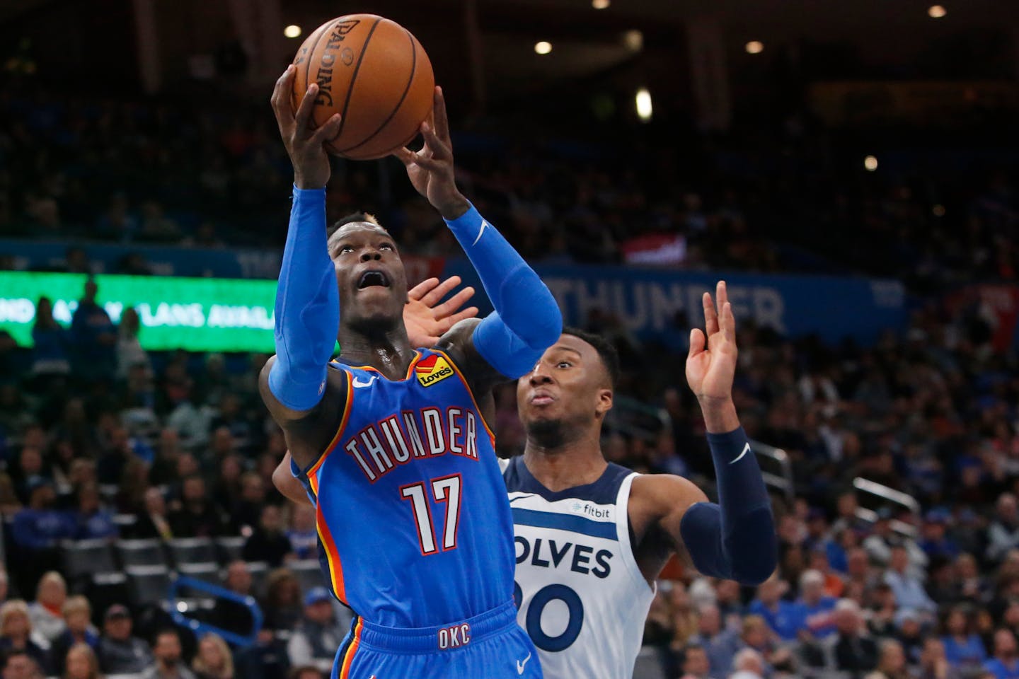 Oklahoma City guard Dennis Schroder shoots in front of Timberwolves guard Josh Okogie