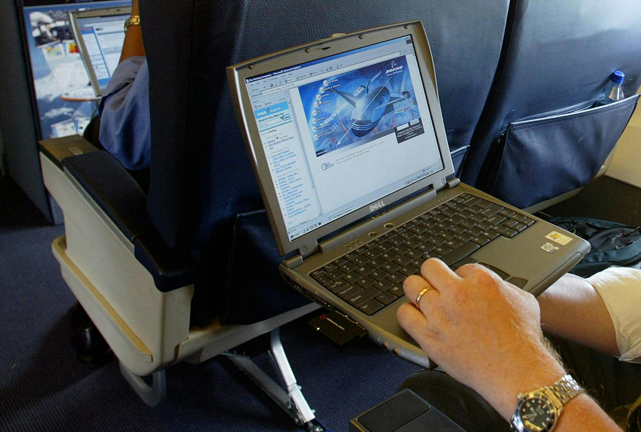 FILE - This is a July 29, 2002 file photo of a laptop is used on a plane . Britain's government Tuesday March 21, 2017 banned electronic devices in the carry-on bags of passengers traveling to the U.K. from six countries, following closely on a similar ban imposed by the United States. (Chris Ison/PA, File via AP) ORG XMIT: MIN2017032113033615