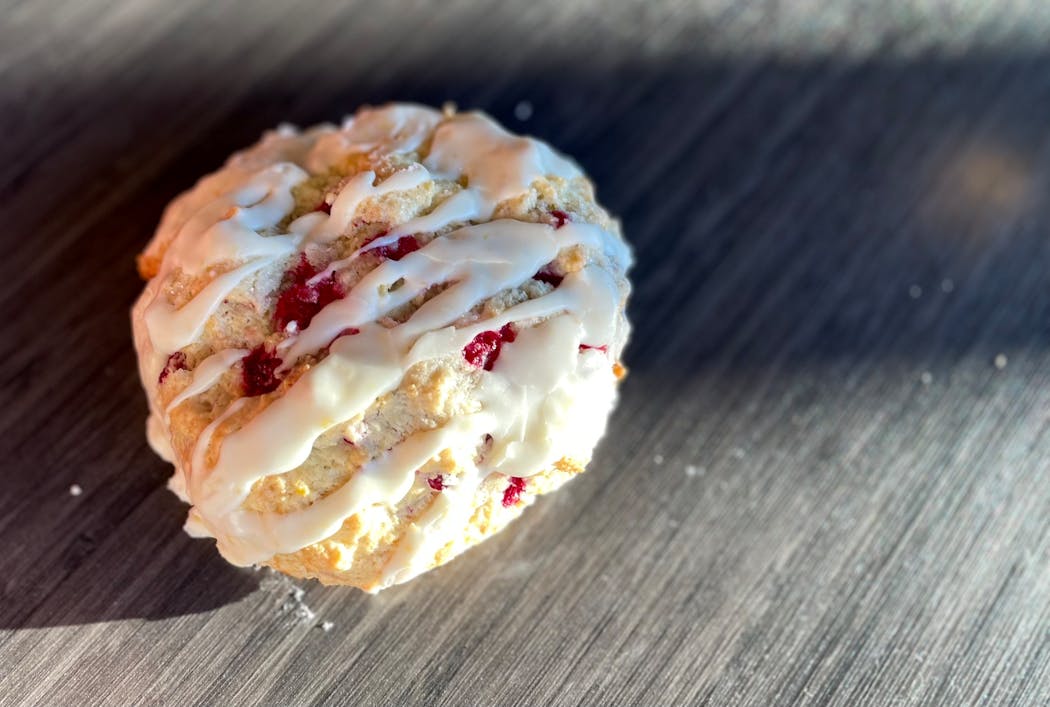 A crumbly scone packed with lingonberries and topped with frosting.