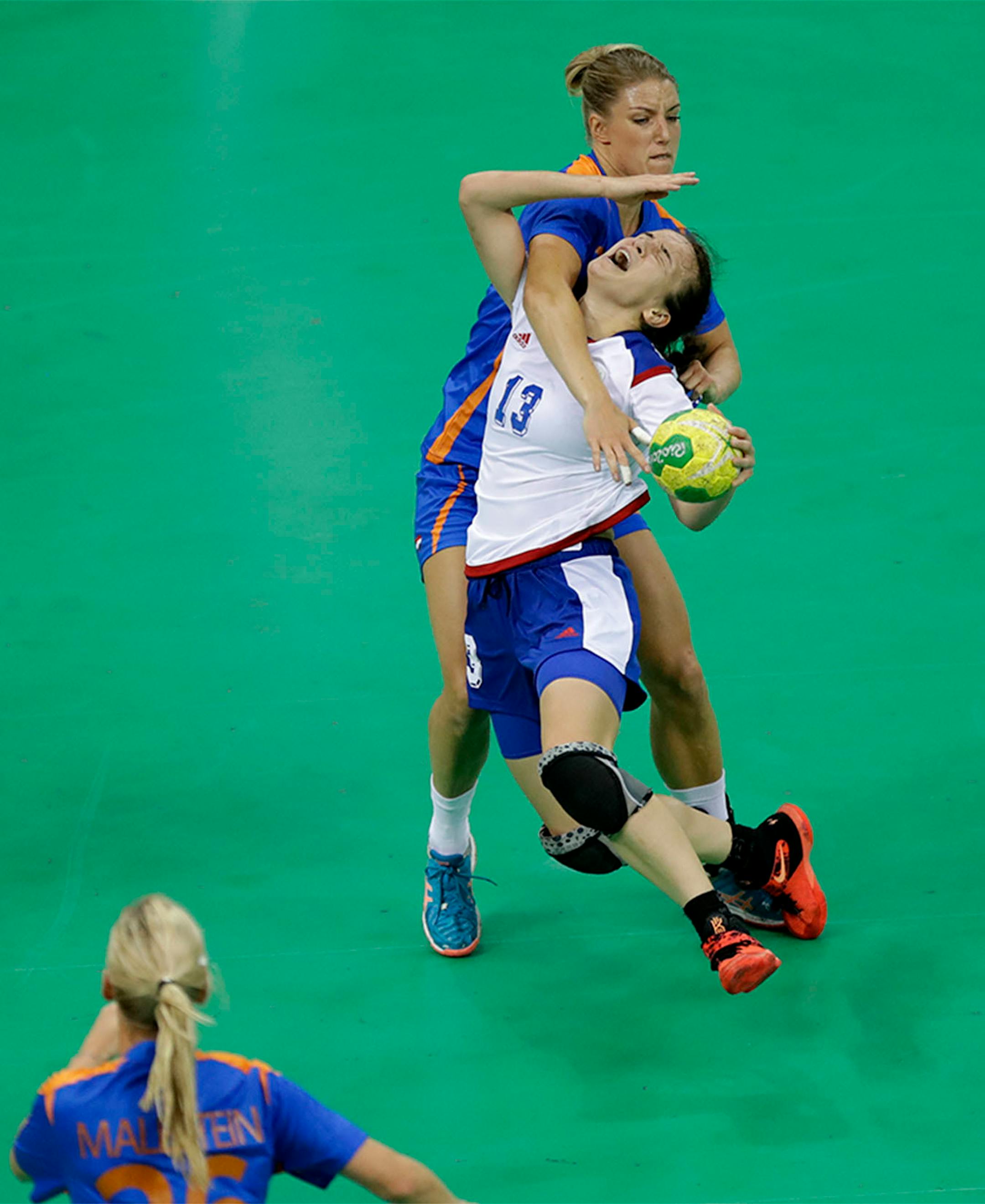 Netherlands' Nycke Groot, background, stops Russia's Anna Vyakhireva during the women's preliminary handball match between the Netherlands and Russia at the 2016 Summer Olympics in Rio de Janeiro, Brazil, Sunday, Aug. 14, 2016.