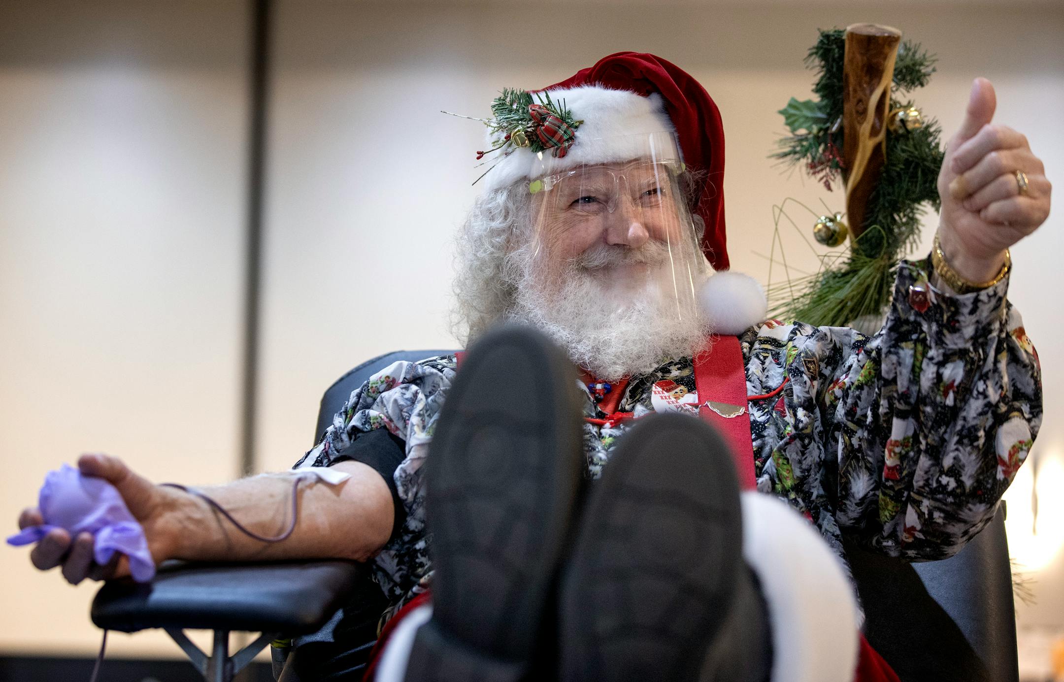 Kellie Ziel drew blood from Santa Claus aka Daniel Hanson donated blood at Inwood Oaks in Oakdale, Minn. during the 8th annual Red Cross 12 Hours of Giving blood drive.