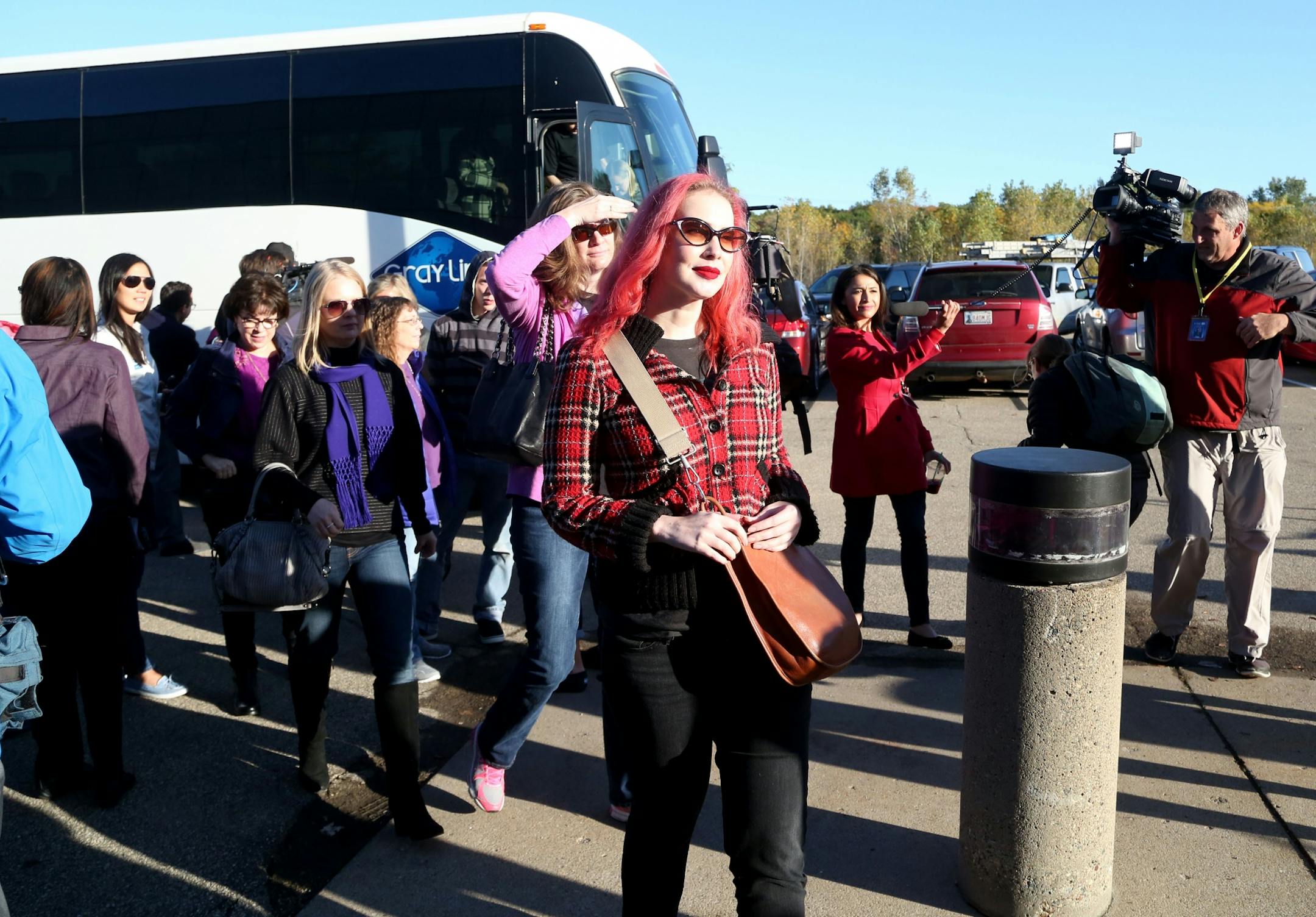 Some of the first Paisley Park tour ticket holders disembark on the bus and into Paisley for the new Paisley Park Tour Thursday, Oct. 6, 2016, in Chanhassen, MN.