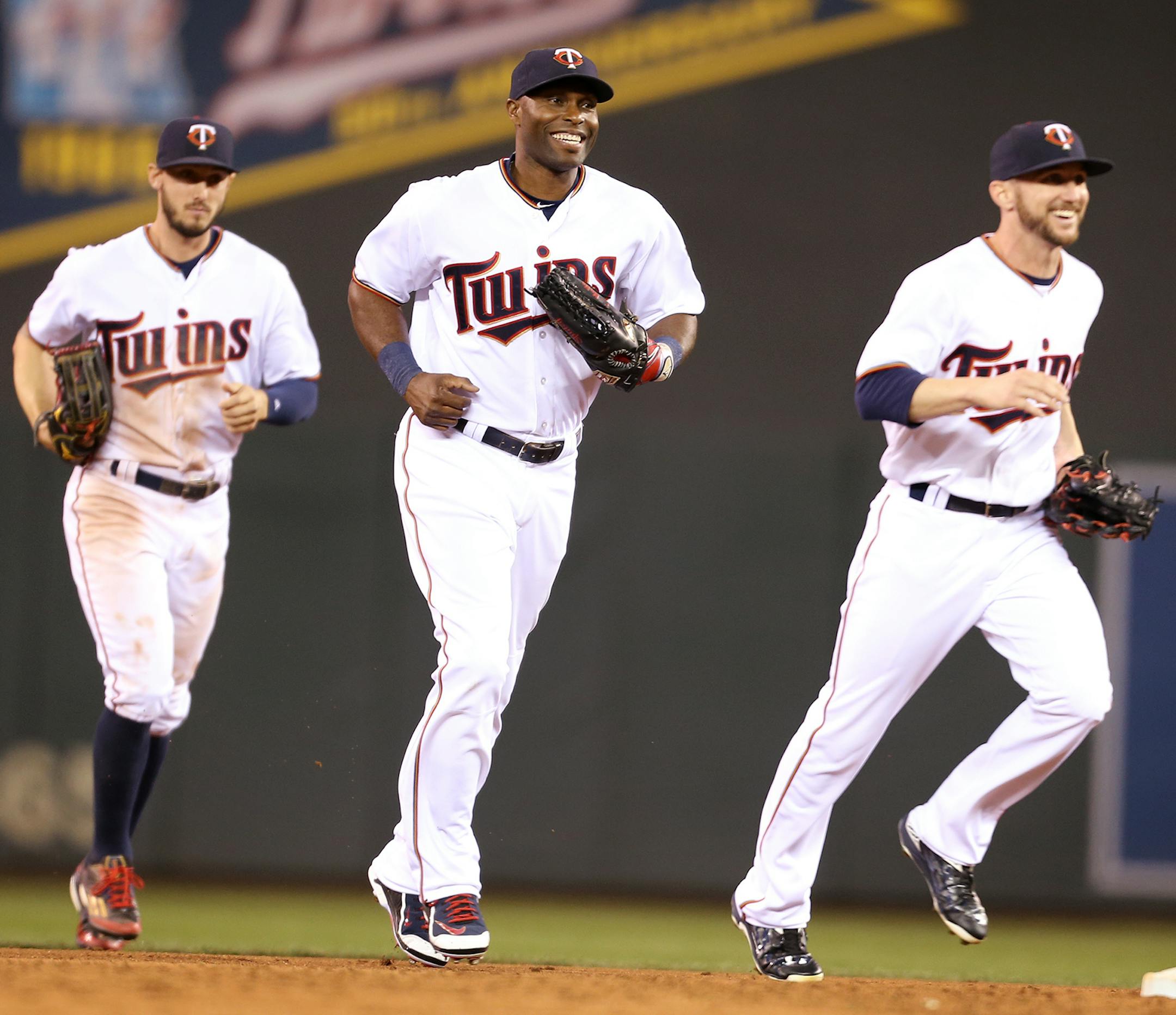 Jordan Schafer, from left, Torii Hunter, and Shane Robinson run in from outfield to celebrate the Minnesota Twins 8-7 win over the Oakland Athletics at Target Field in Minneapolis on Monday, May 4, 2015. ] LEILA NAVIDI leila.navidi@startribune.com / ORG XMIT: MIN1505042302500955