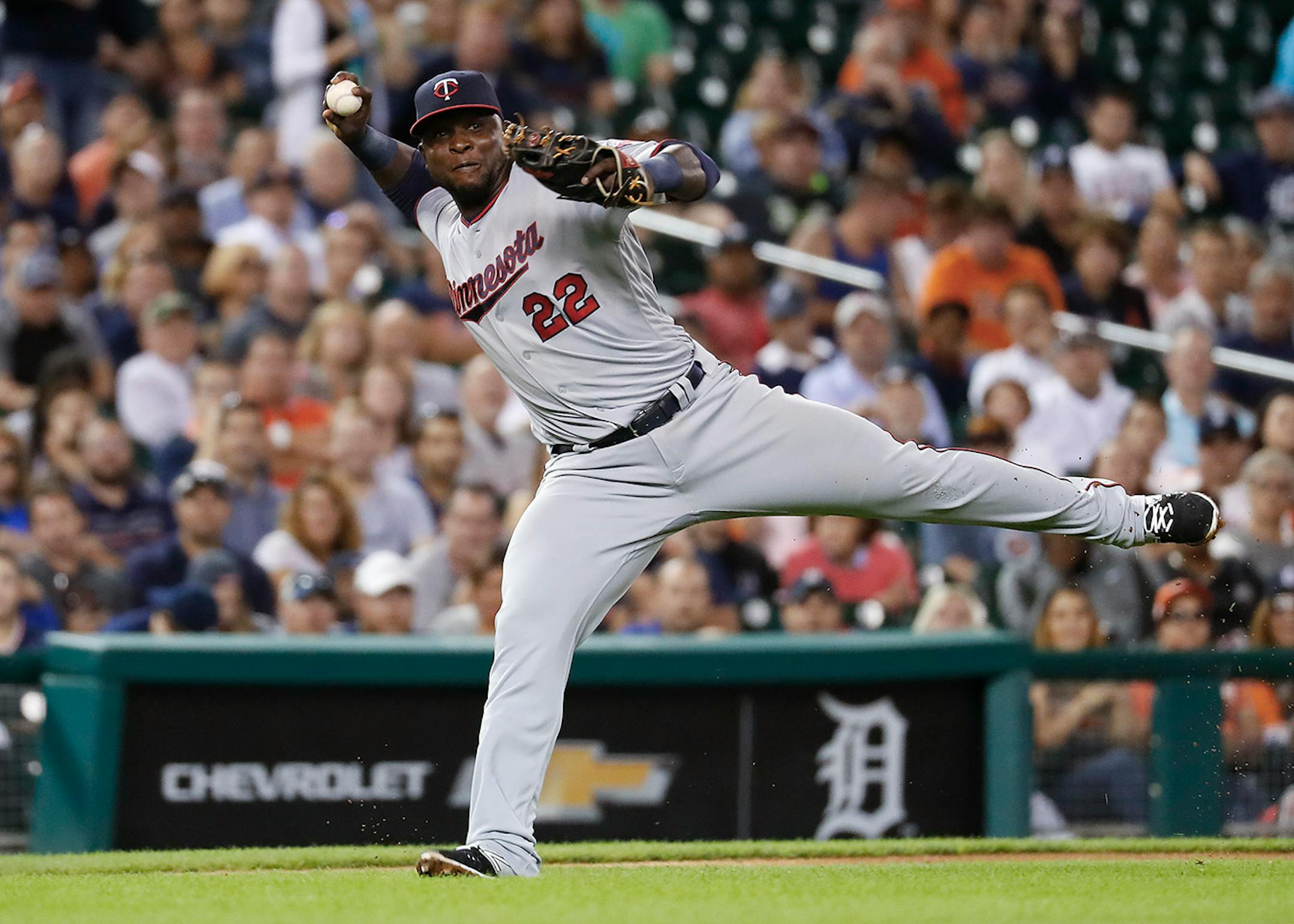 Minnesota Twins third baseman Miguel Sano (22) throws to first base for an out against Detroit Tigers' J.D. Martinez in the third inning during a baseball game in Detroit, Monday, Sept. 12, 2016.