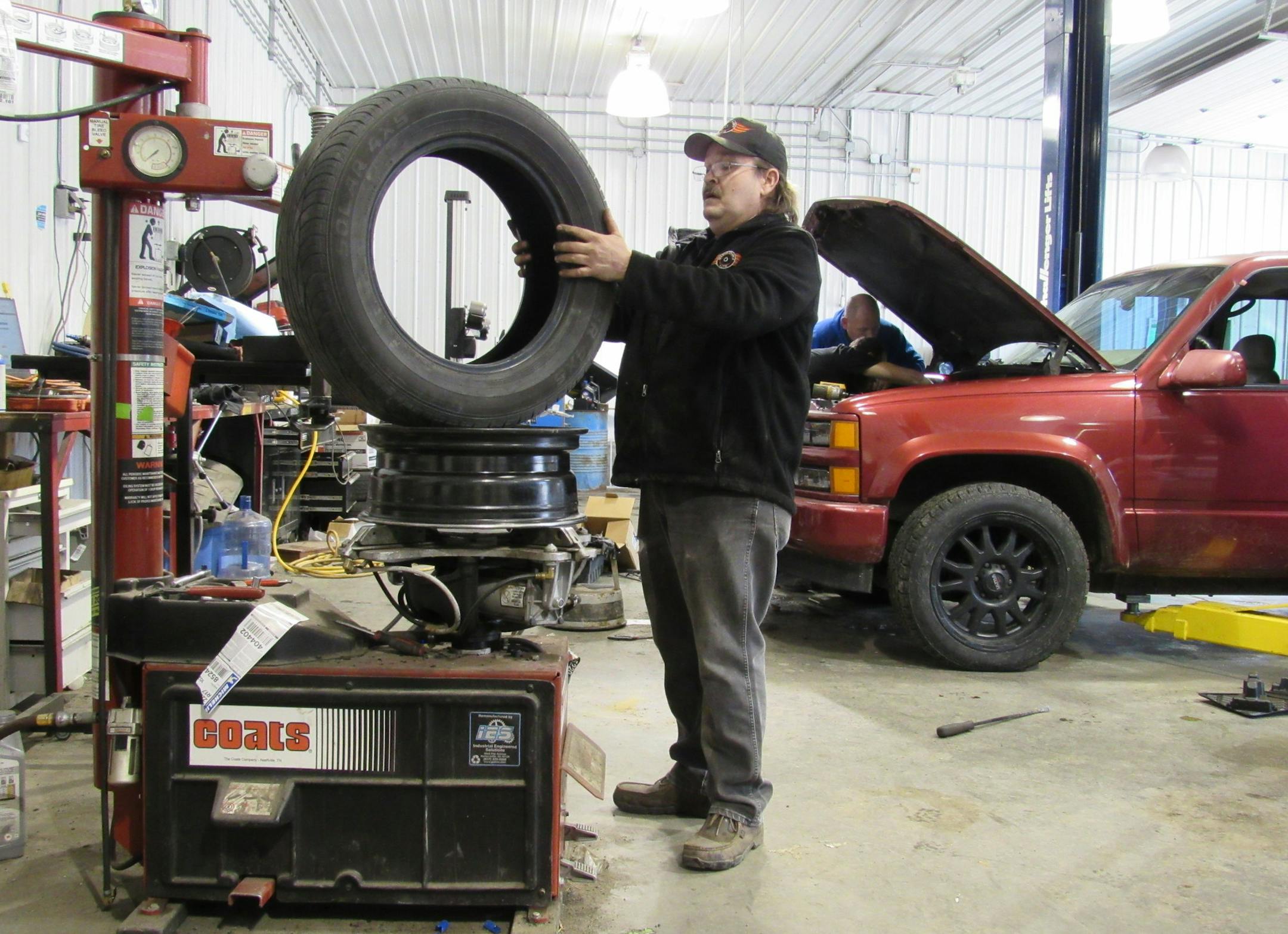 Lonnie Thomason works to repair a tire at Second Chance Auto in Louisa, Ky. The shop trains people to be mechanics while they are in treatment for addiction. (Bill Estep/Lexington Herald-Leader/TNS)
