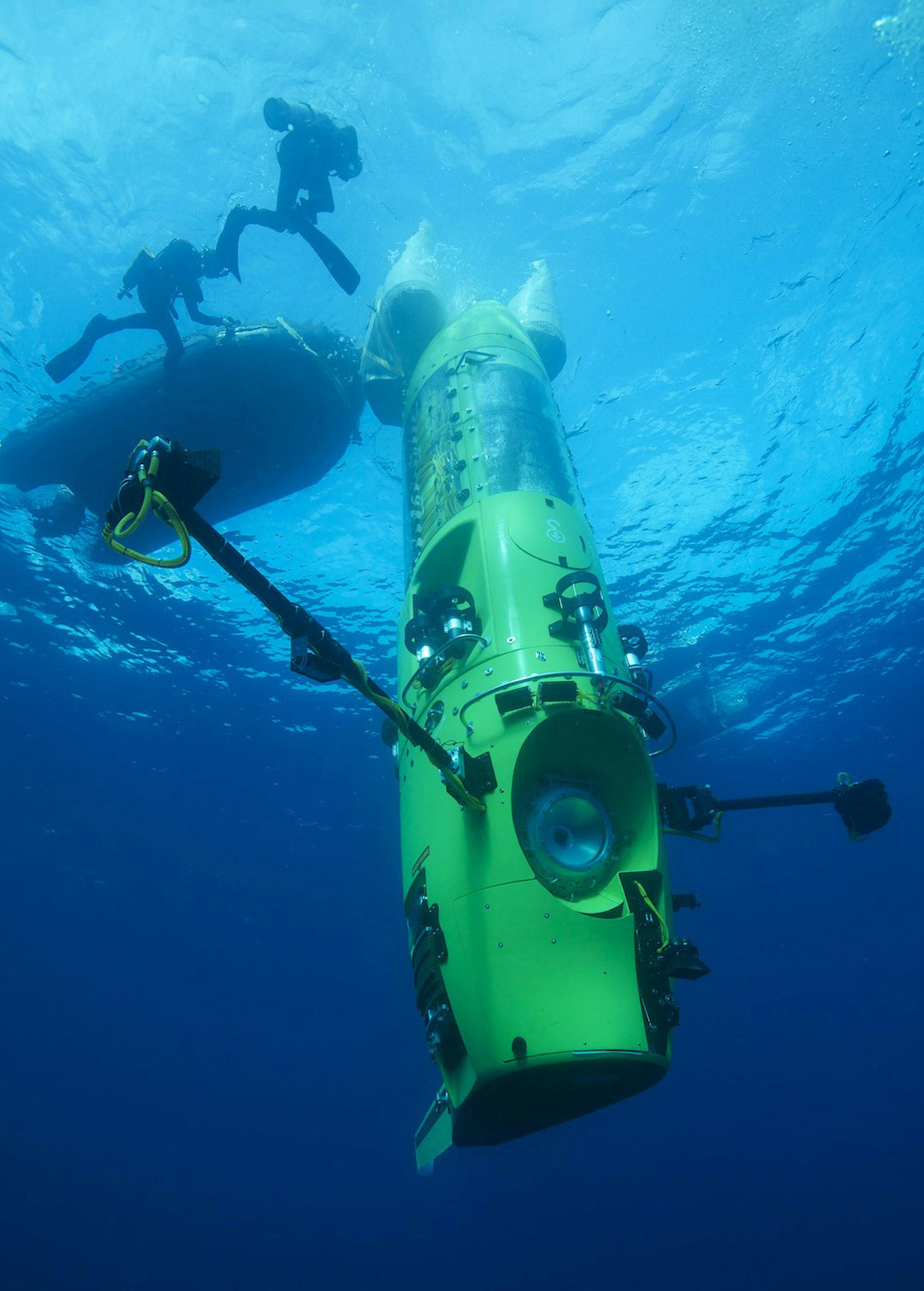 This February 2012 handout photo provided by National Geographic shows the DEEPSEA CHALLENGER submersible begining its first test dive off the coast of Papua New Guinea. Earth's lost frontier, the deepest part of the oceans where the pressure is like three SUVs sitting on your little tow, is about to be explored first-hand. It's been more than half a century since man dared to plunge that deep. Earth's lost frontier is about to be explored firsthand after more than half a century. It's a mission